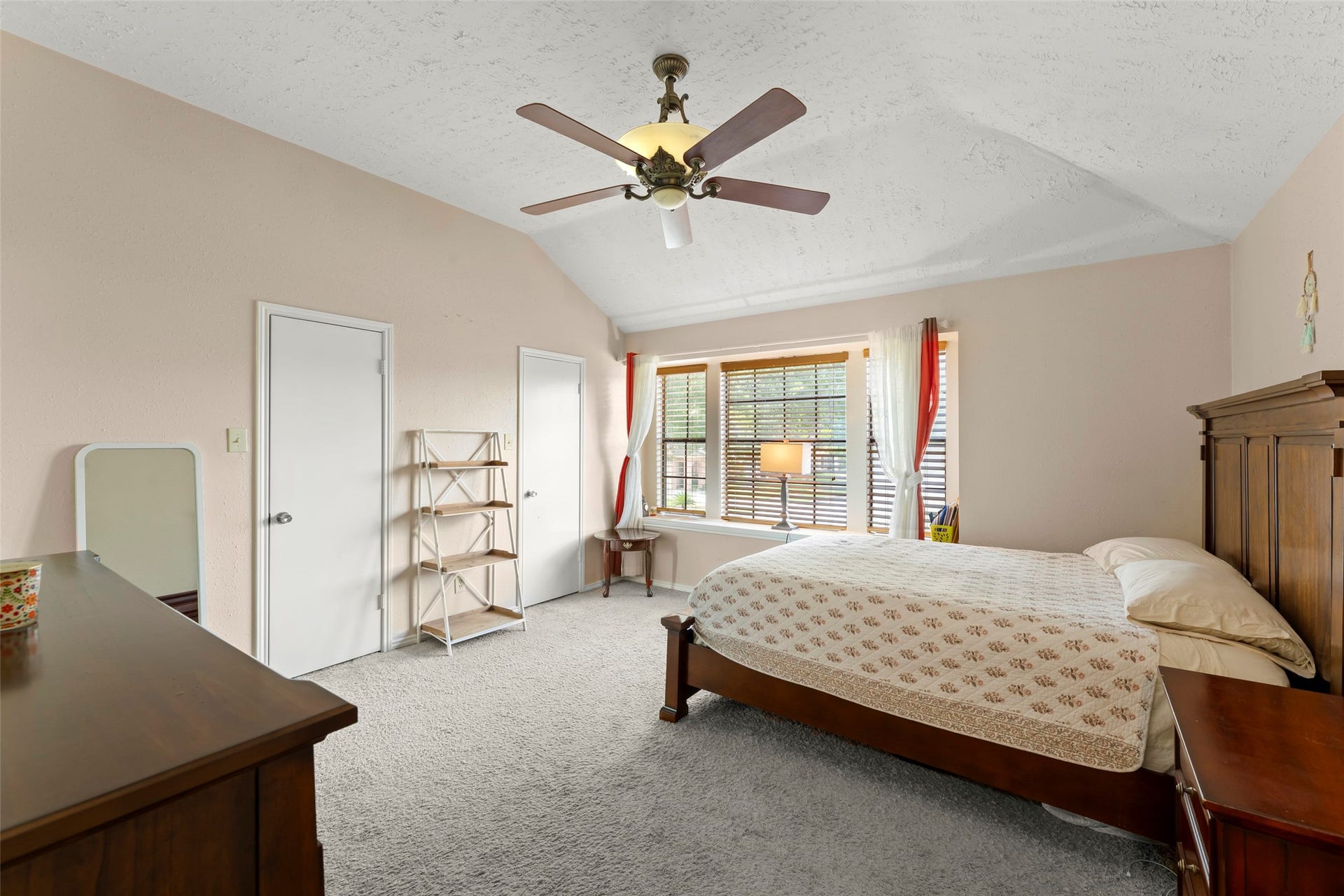 2033 Wildwood Ridge Drive, Missouri City, TX 77489 Versatile upper-level bedroom featuring warm carpet flooring, a functional layout, and a seamless flow from the central hallway.