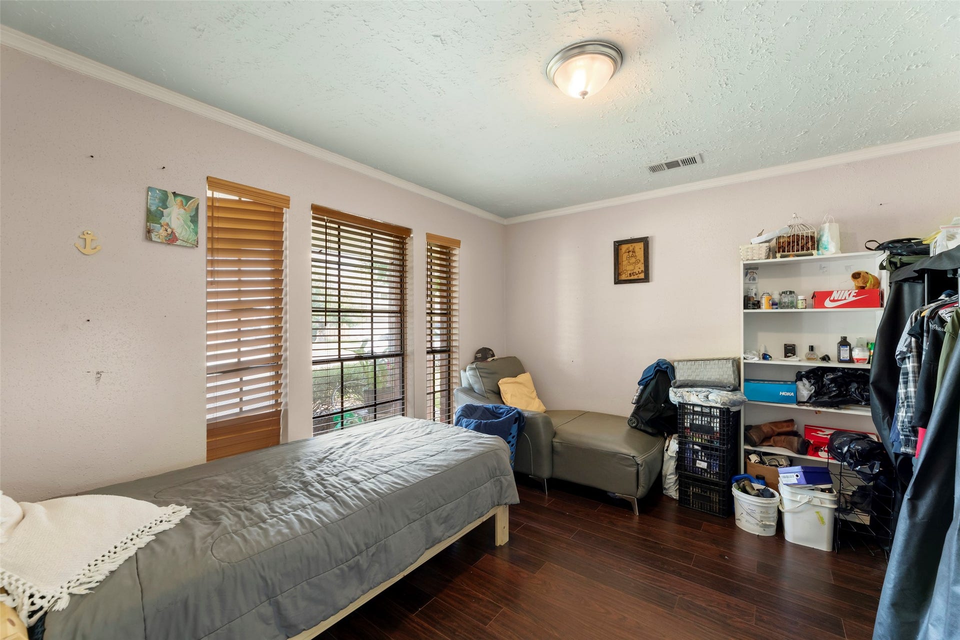 2033 Wildwood Ridge Drive, Missouri City, TX 77489 Inviting bedroom space highlighted by elegant dark wood floors, clean lines, and a warm, polished aesthetic.