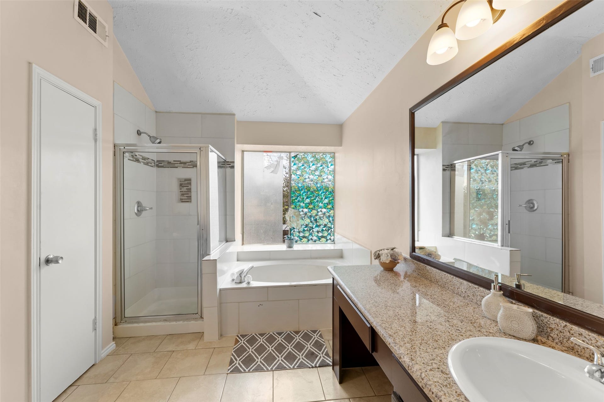 2033 Wildwood Ridge Drive, Missouri City, TX 77489 Bright and welcoming bathroom vanity area illuminated by abundant natural light, featuring a granite countertop!