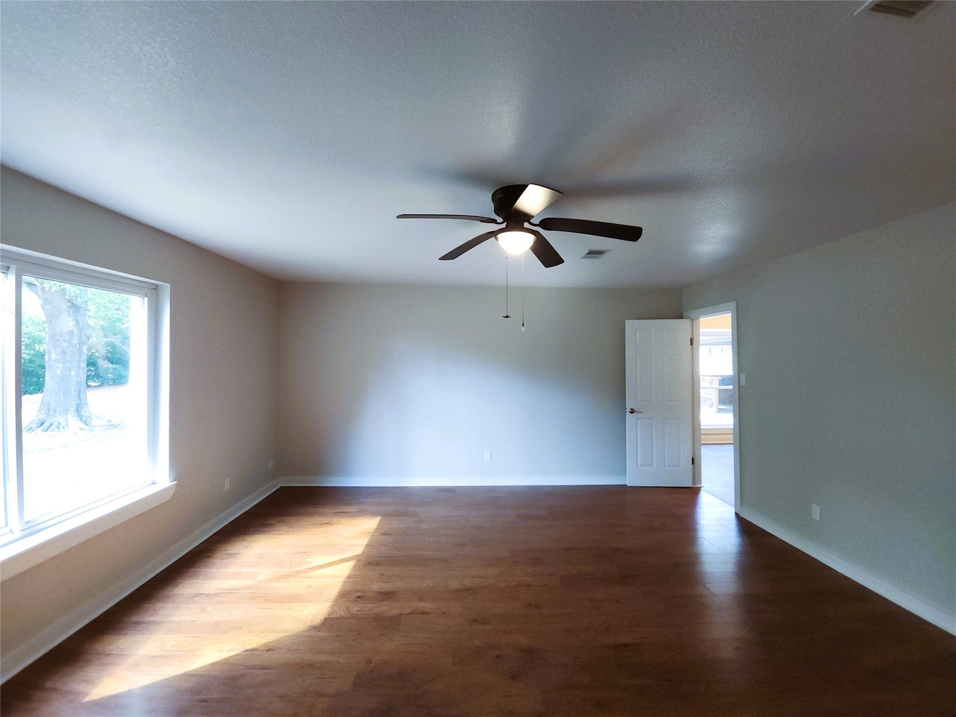 557 Fm 2693 Road E, New Waverly, TX 77358 This primary bedroom is large with an attached bathroom including dual closets and a walk-in shower.