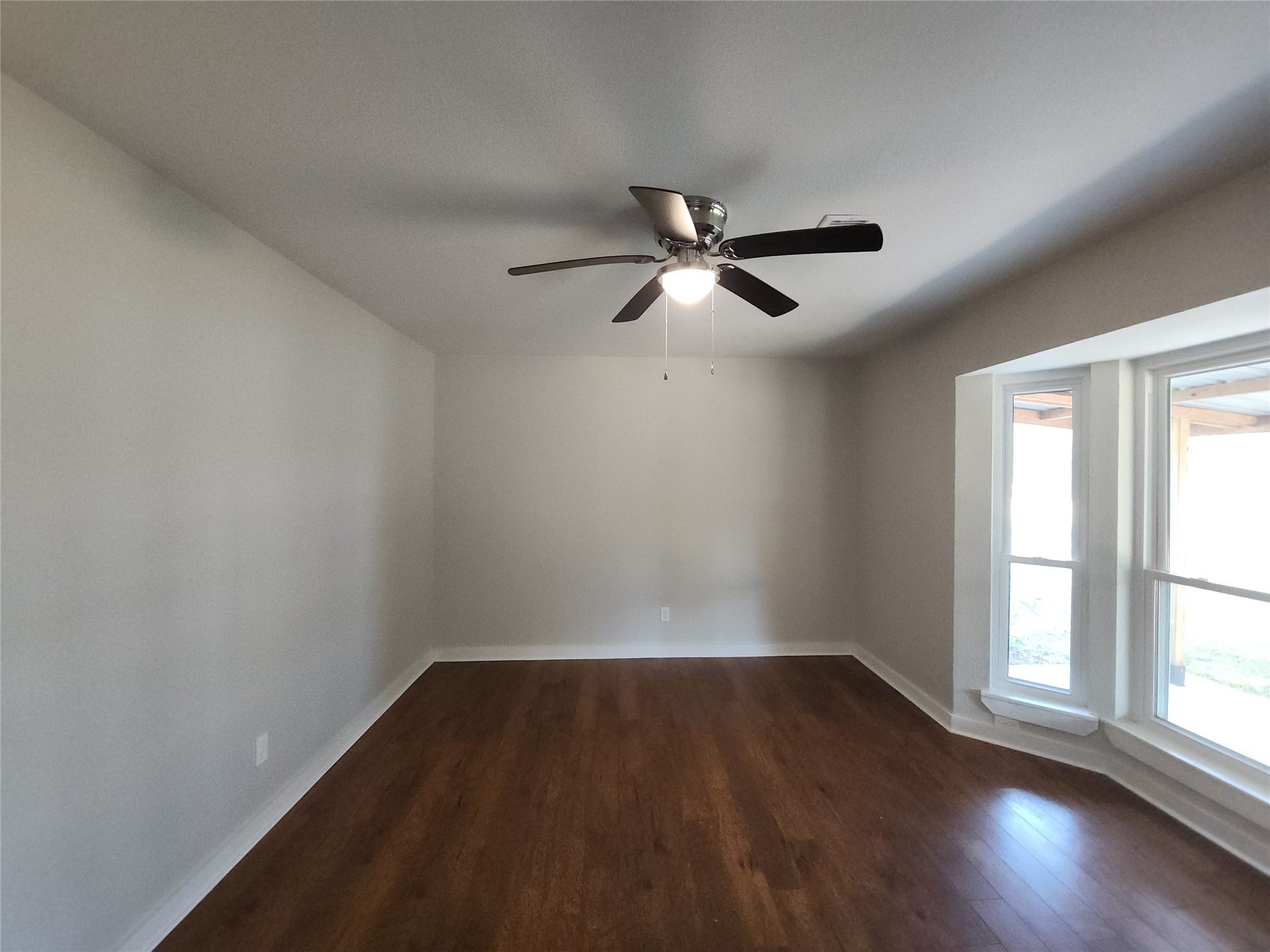 557 Fm 2693 Road E, New Waverly, TX 77358 Spacious room featuring abundant natural light from large bay windows.