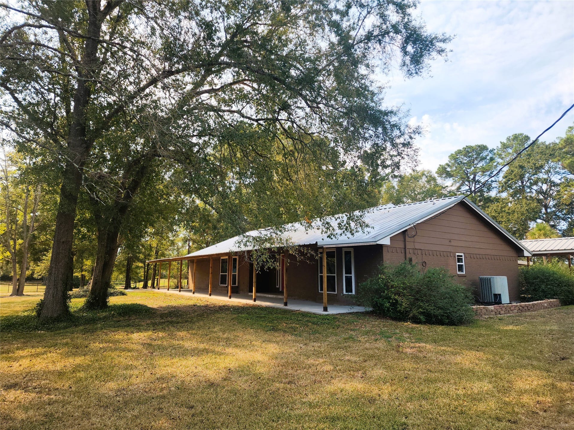 557 Fm 2693 Road E, New Waverly, TX 77358 65'x9x covered front porch with views of the pond across the street.
