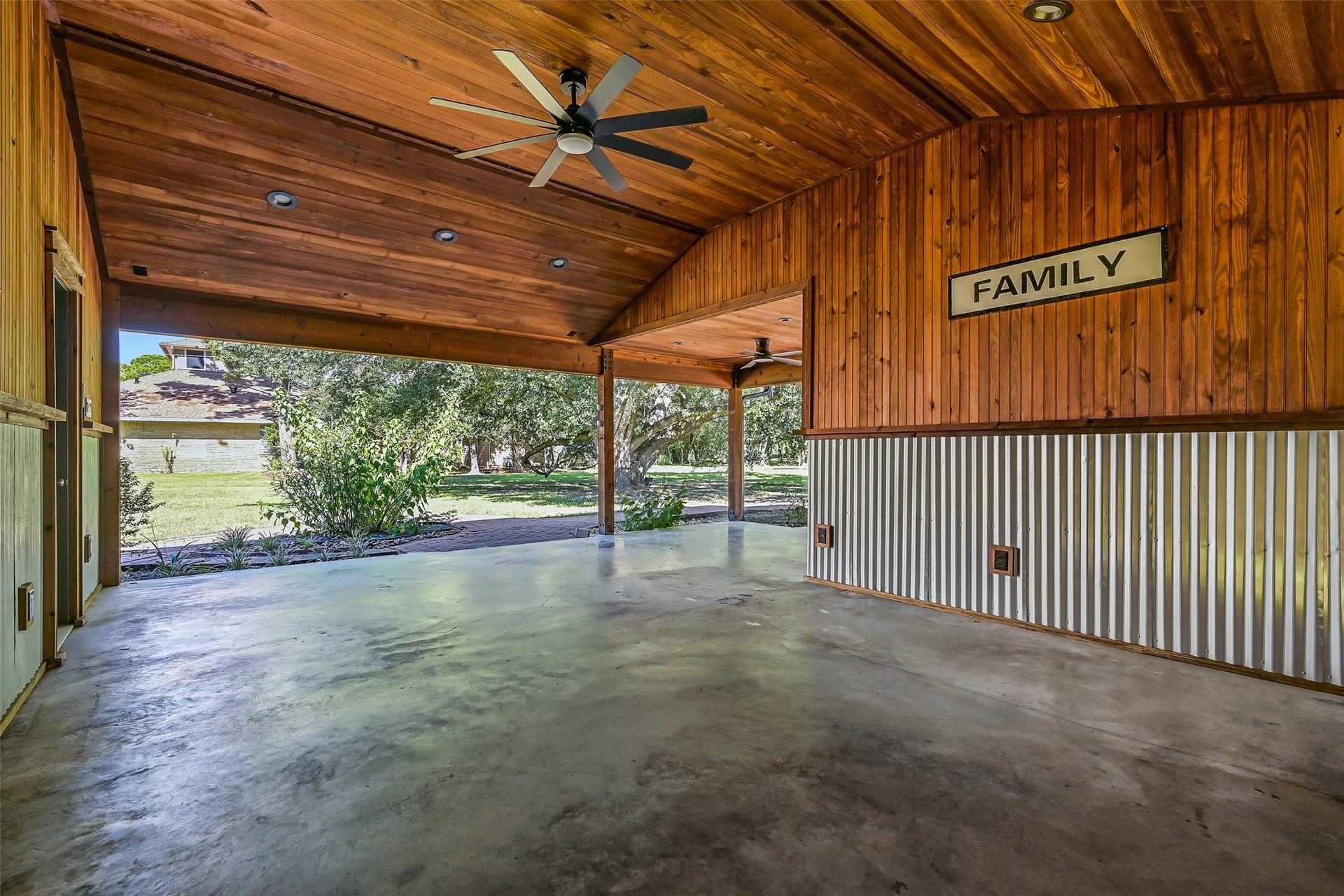 921 Falling Leaf Drive, Friendswood, TX 77546 Tucked behind the detached 2-car garage, an expansive covered outdoor living area features warm wood-plank walls & ceiling, recessed lighting, ceiling fans and numerous electrical outlets, creating a fantastic sheltered space overlooking the backyard.