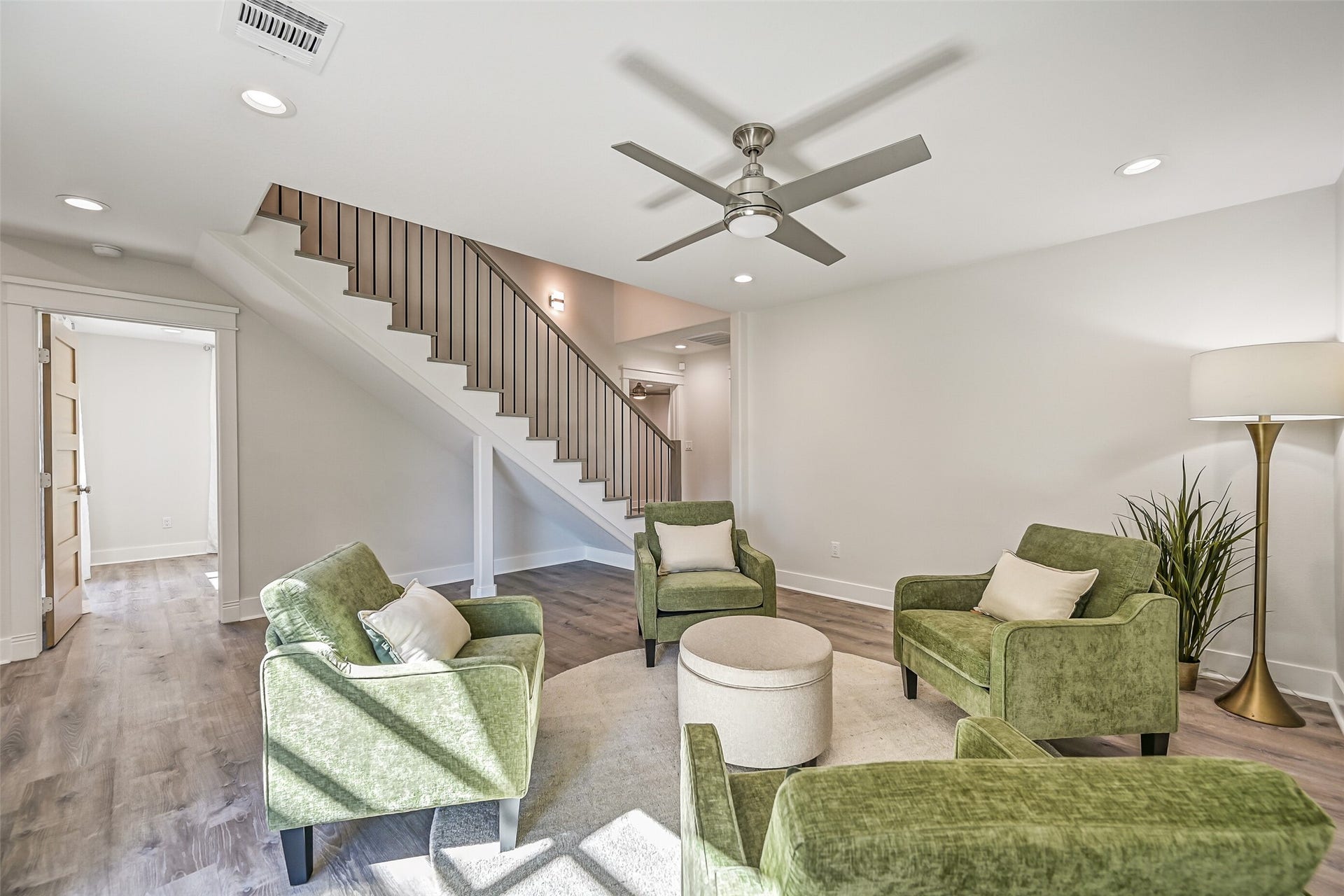921 Falling Leaf Drive, Friendswood, TX 77546 Another view highlights the impressive size of this flexible first-floor living space and its location at the base of the contemporary staircase. The nearby bedroom wing makes it equally well suited for a playroom, study, media space or casual sitting area.