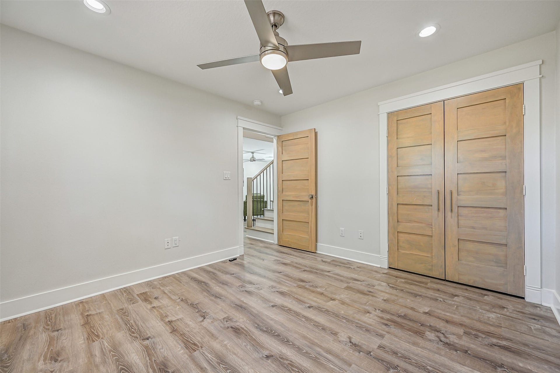 921 Falling Leaf Drive, Friendswood, TX 77546 The second 12' x 11' secondary bedroom offers recessed lighting, a modern lighted ceiling fan, luxury vinyl plank flooring, neutral finishes & a generous double-door closet with contemporary solid wood doors.