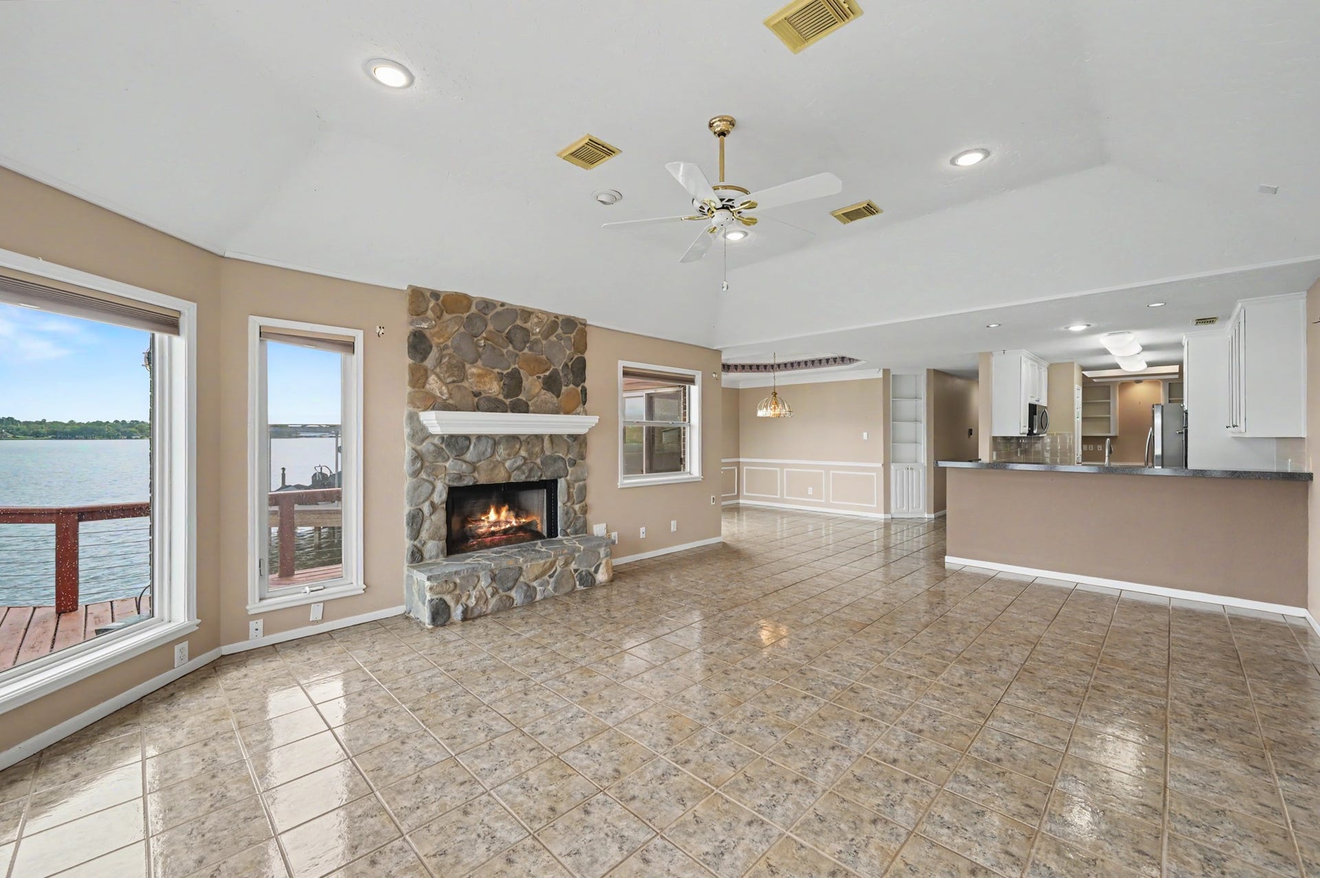 12842 Pelican Island Drive, Willis, TX 77318 Living Area with focal point Fire Place surrounded by windows with a view.