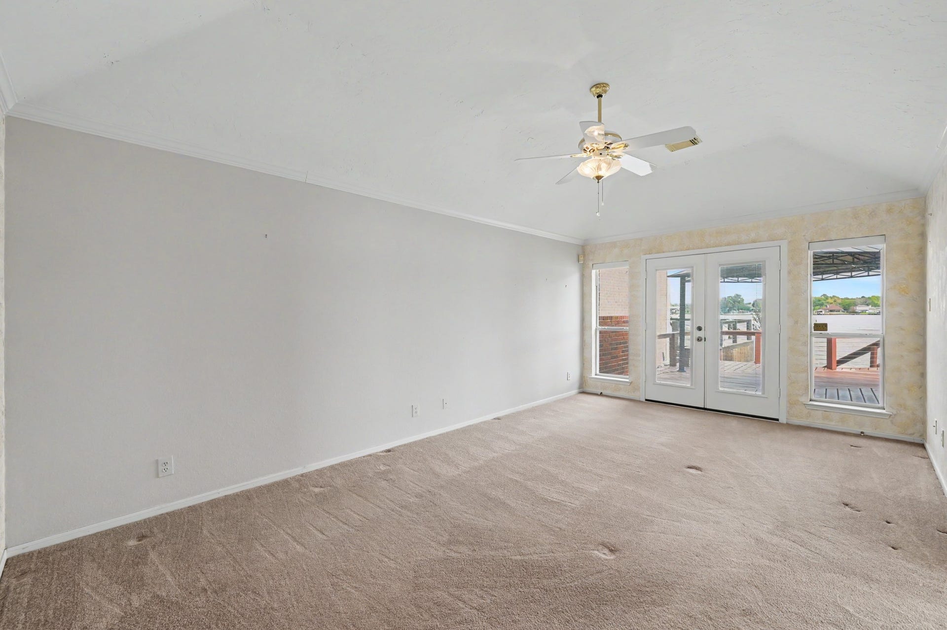 12842 Pelican Island Drive, Willis, TX 77318 Spacious Primary Suite with French Doors leading to the deck.