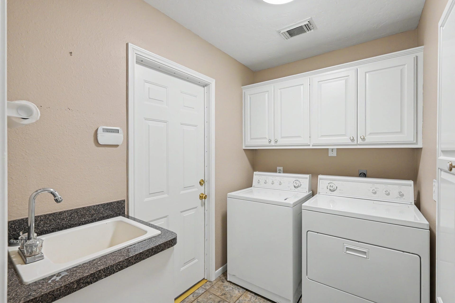 12842 Pelican Island Drive, Willis, TX 77318 Utility Room with Utility Sink, door leads to garage.