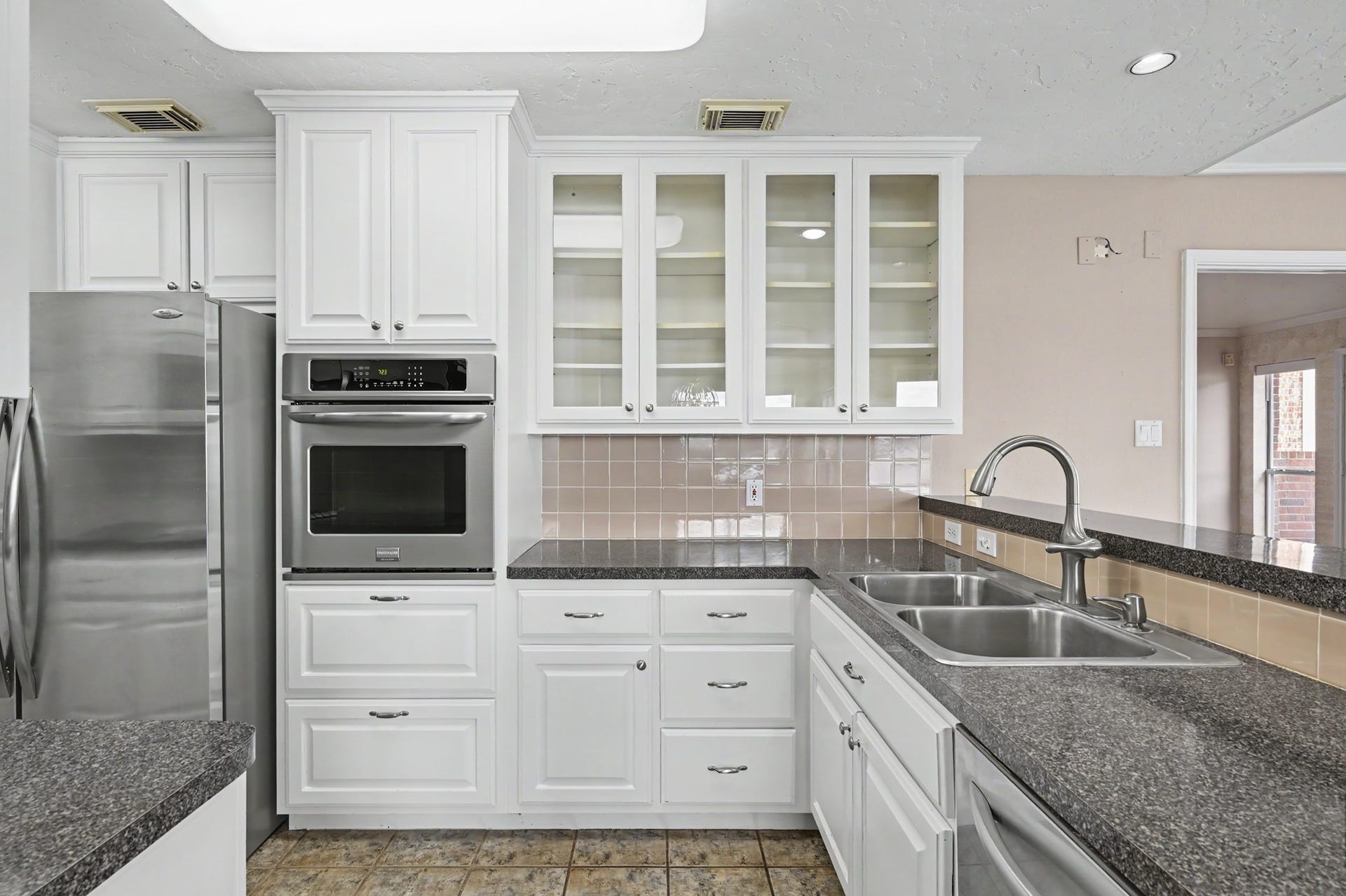12842 Pelican Island Drive, Willis, TX 77318 Freshly painted cabinets with stainless appliances