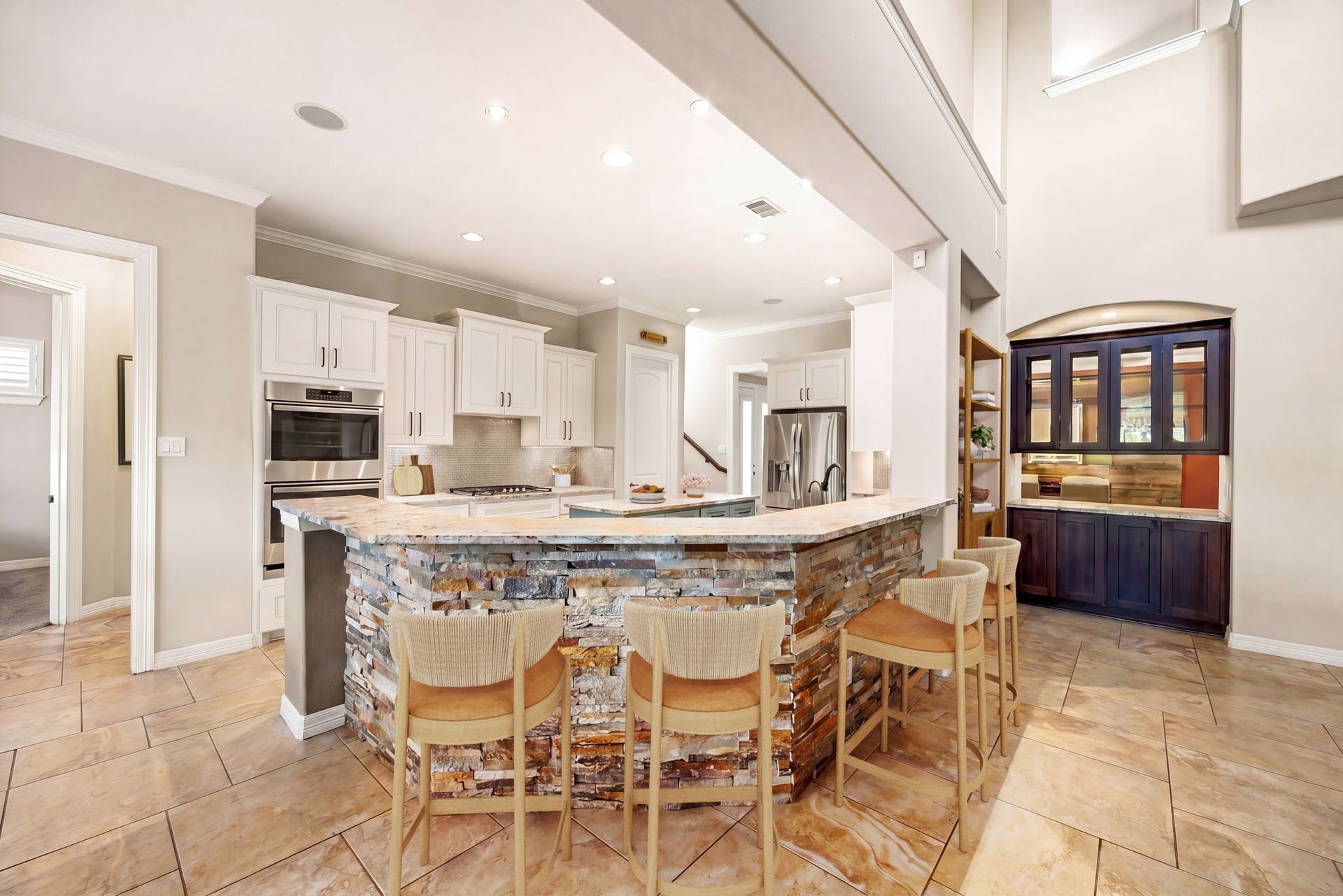5102 Hawthorne Bend Drive, Katy, TX 77494 Now THIS is a showstopper! The dramatic stacked stone breakfast bar with granite countertops, built-in oven, stainless appliances, white cabinetry, and a stunning wet bar nook make this kitchen unlike anything else. Entertaining just got a serious upgrade. *Virtually Staged