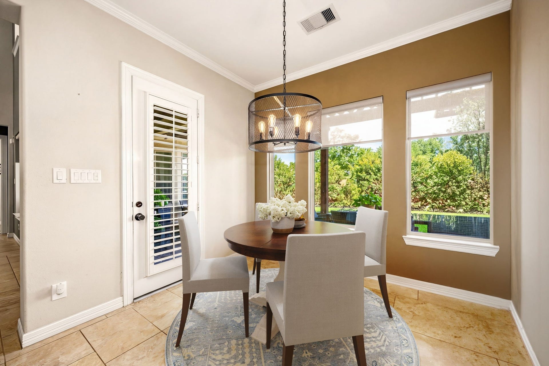 5102 Hawthorne Bend Drive, Katy, TX 77494 The sweetest spot in the house! This charming breakfast nook features a stylish drum pendant light, crown molding, and oversized windows with serene backyard view, the perfect place to start your day. *Virtually Staged