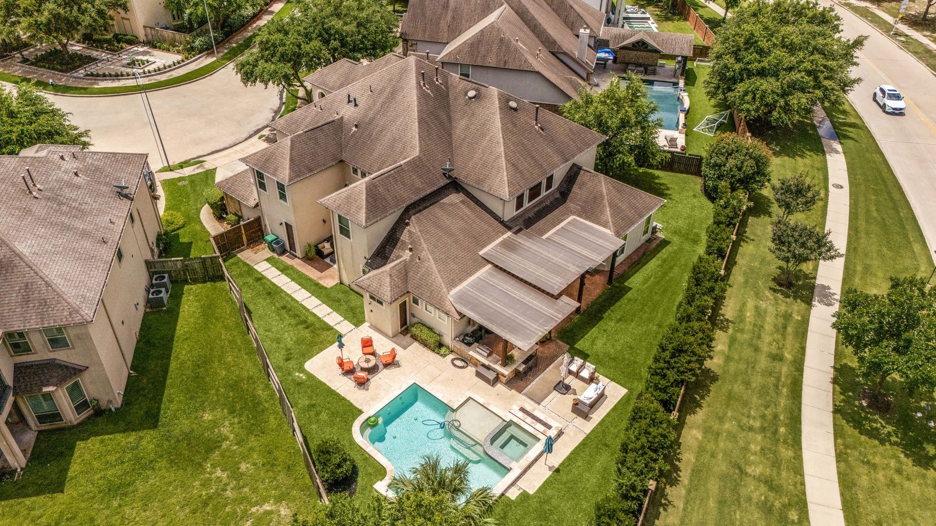 5102 Hawthorne Bend Drive, Katy, TX 77494 This incredible aerial shot showcases the expansive lot, pool and spa, covered pergola, outdoor kitchen, and lush green yard, all nestled on a prime cul-de-sac in Cinco Ranch Southwest.