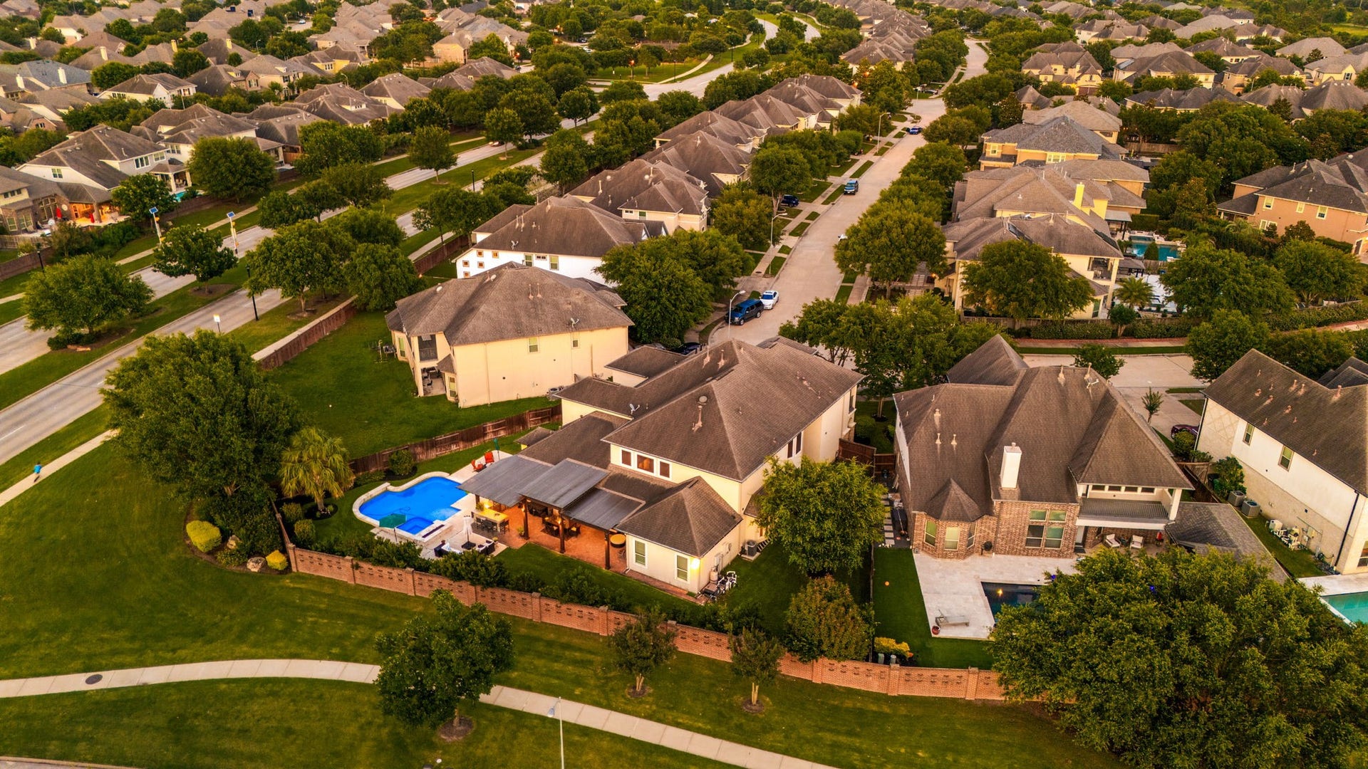 5102 Hawthorne Bend Drive, Katy, TX 77494 Tree-lined streets, lush green lawns, and a tight-knit community vibe, this aerial shot captures exactly why Cinco Ranch Southwest is one of Katy's most sought-after communities. Pool and pergola visible right from above!