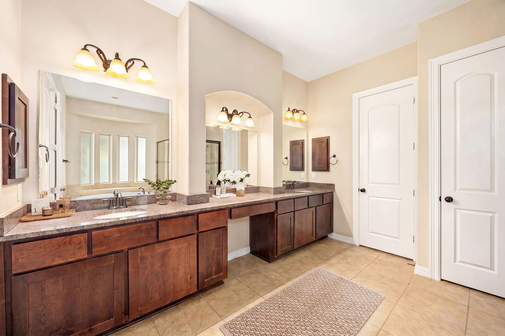 5102 Hawthorne Bend Drive, Katy, TX 77494 Get ready in style! The primary bath boasts dual vanities with rich wood cabinetry, granite countertops, and elegant vanity lighting, his and hers never looked so good.