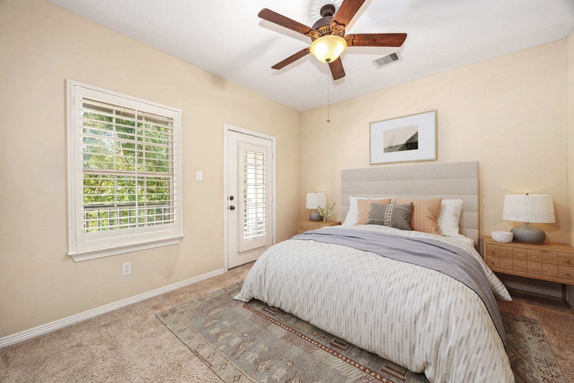5102 Hawthorne Bend Drive, Katy, TX 77494 This bright secondary bedroom features plush carpet, plantation shutters, a ceiling fan, and direct access to the balcony through a charming French door, such a unique and special touch! *Virtually Staged