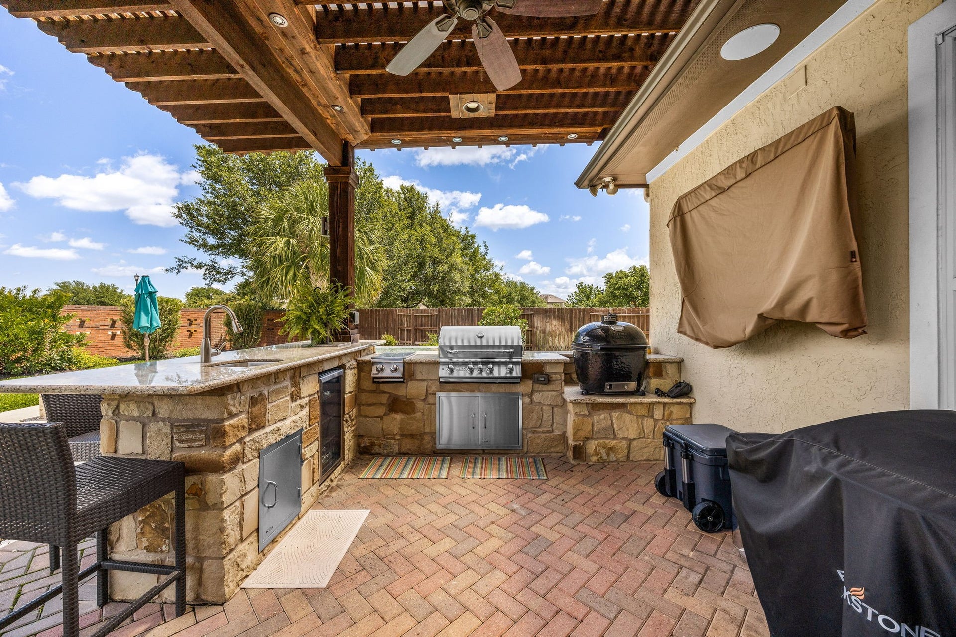 5102 Hawthorne Bend Drive, Katy, TX 77494 Grill masters, this one's for you! This incredible outdoor kitchen features a stacked stone surround, built-in grill, granite countertops, sink, and a gorgeous wood pergola with ceiling fan overhead. Entertaining just reached a whole new level!