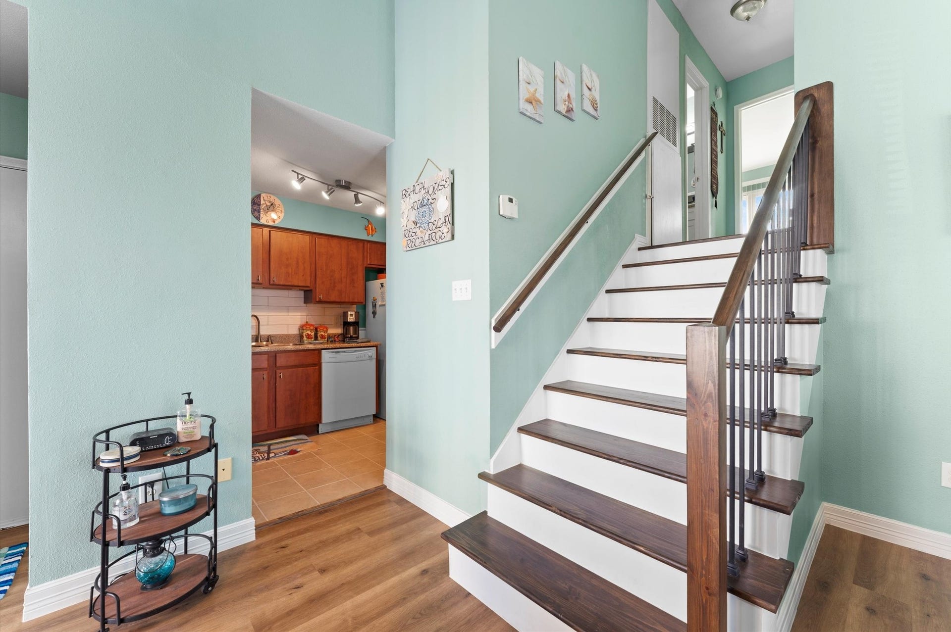 The flooring, stairs, railing, wet bar area, and bathroom were all updated in 2026, along with fresh paint throughout.