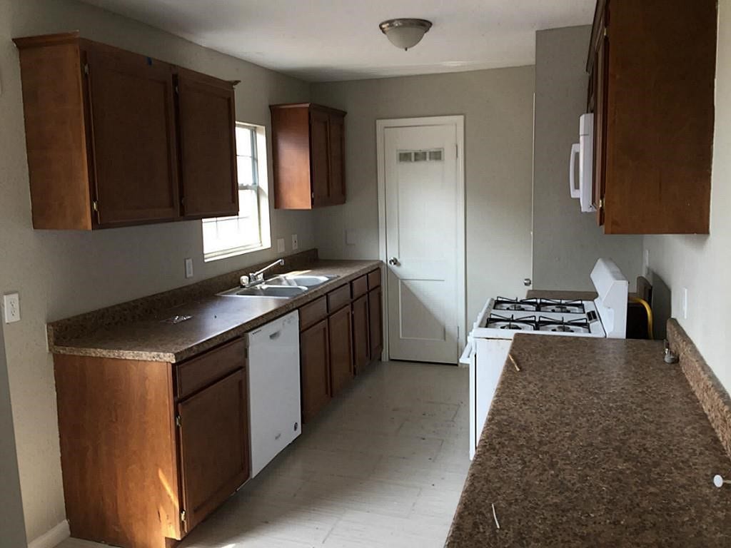 3502 Rosedale Street, Houston, TX 77004 Kitchen with ample natural light, featuring rich wood cabinetry, durable countertops, and modern appliances for a functional cooking space.