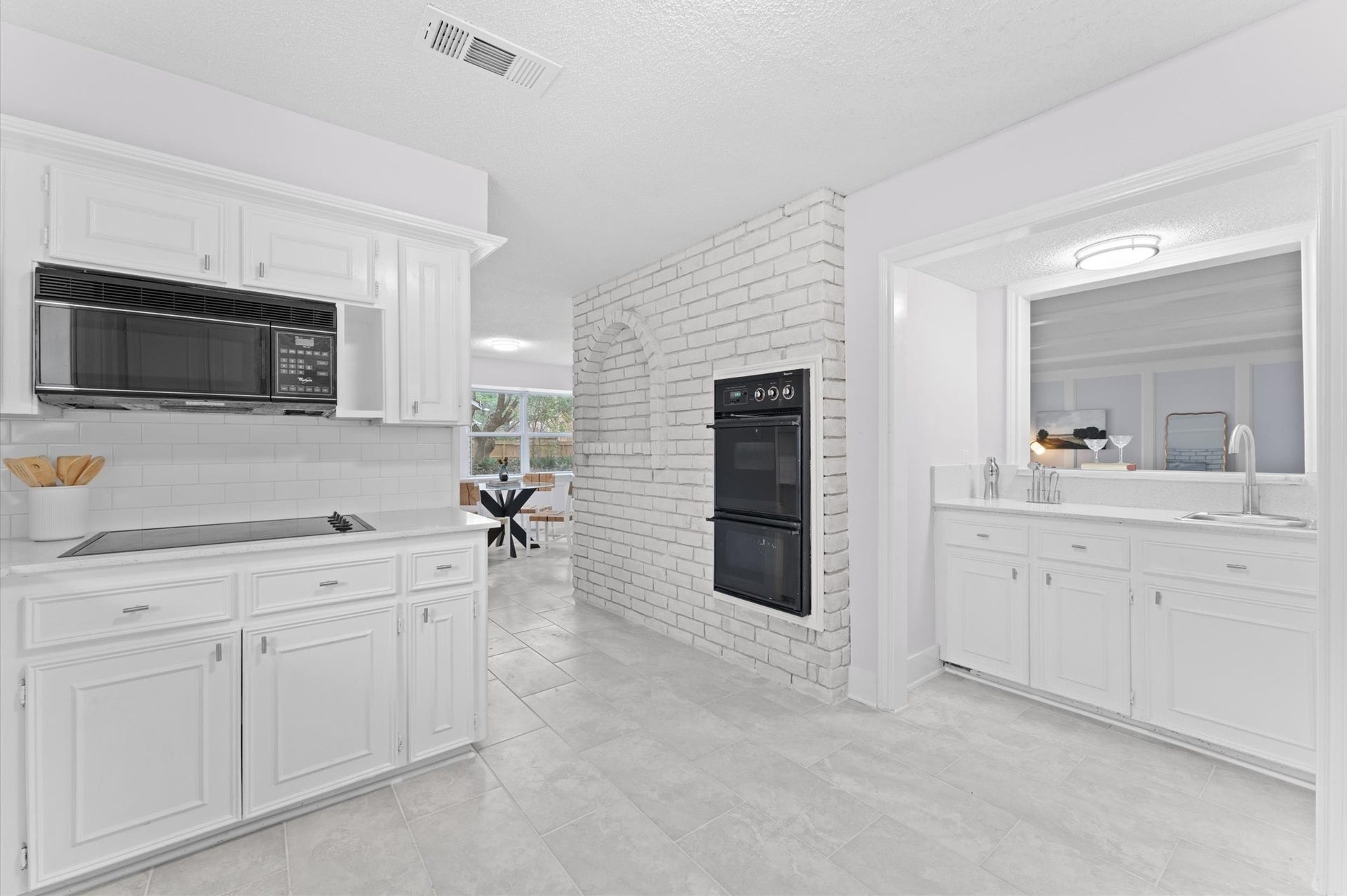 A unique kitchen design offers a bright and airy spot to prepare meals. Located near the breakfast room, the kitchen includes a pass through wet bar, ideal for entertaining.