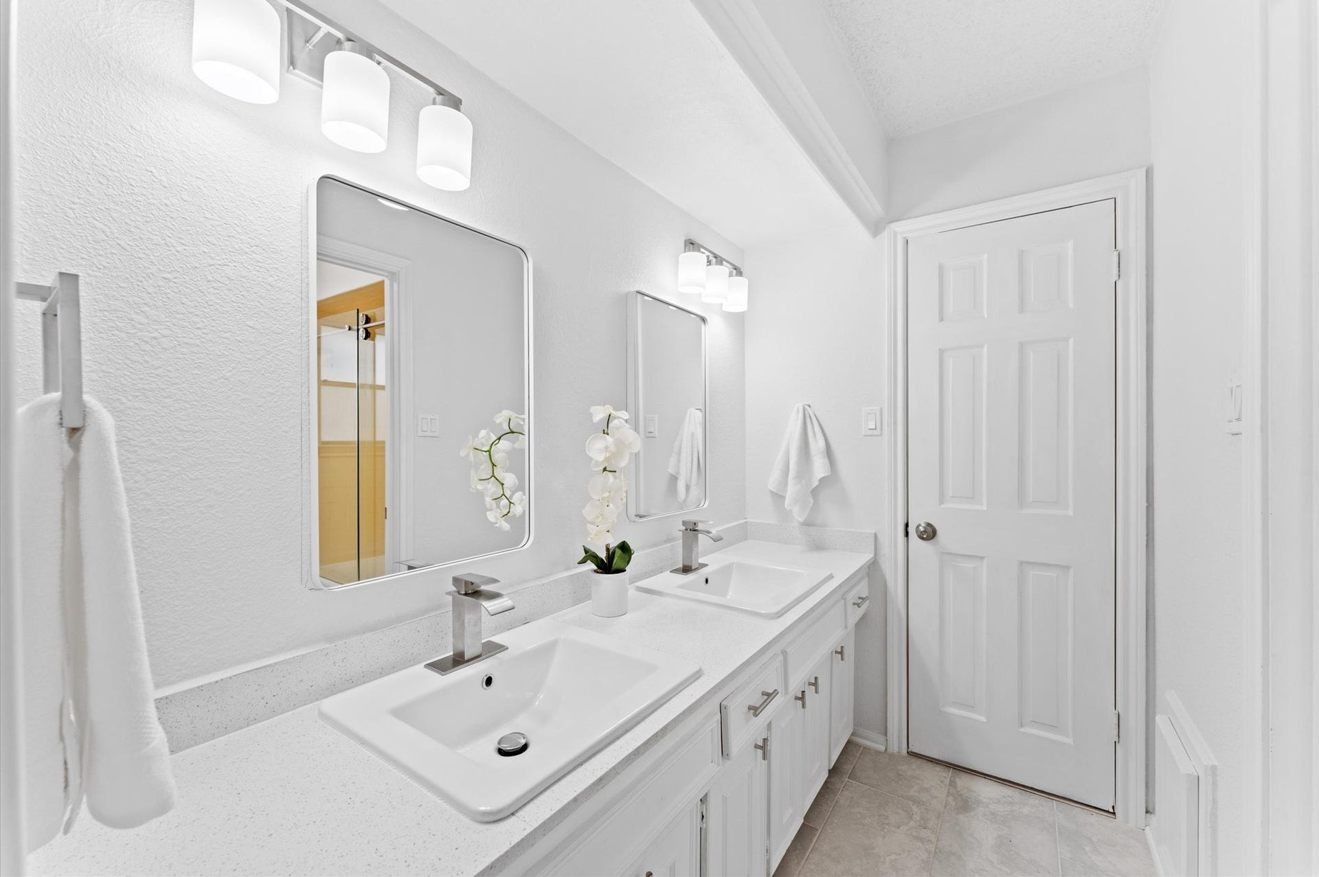 Bathroom 3 has a dual-sink vanity across from a shower/tub combination.