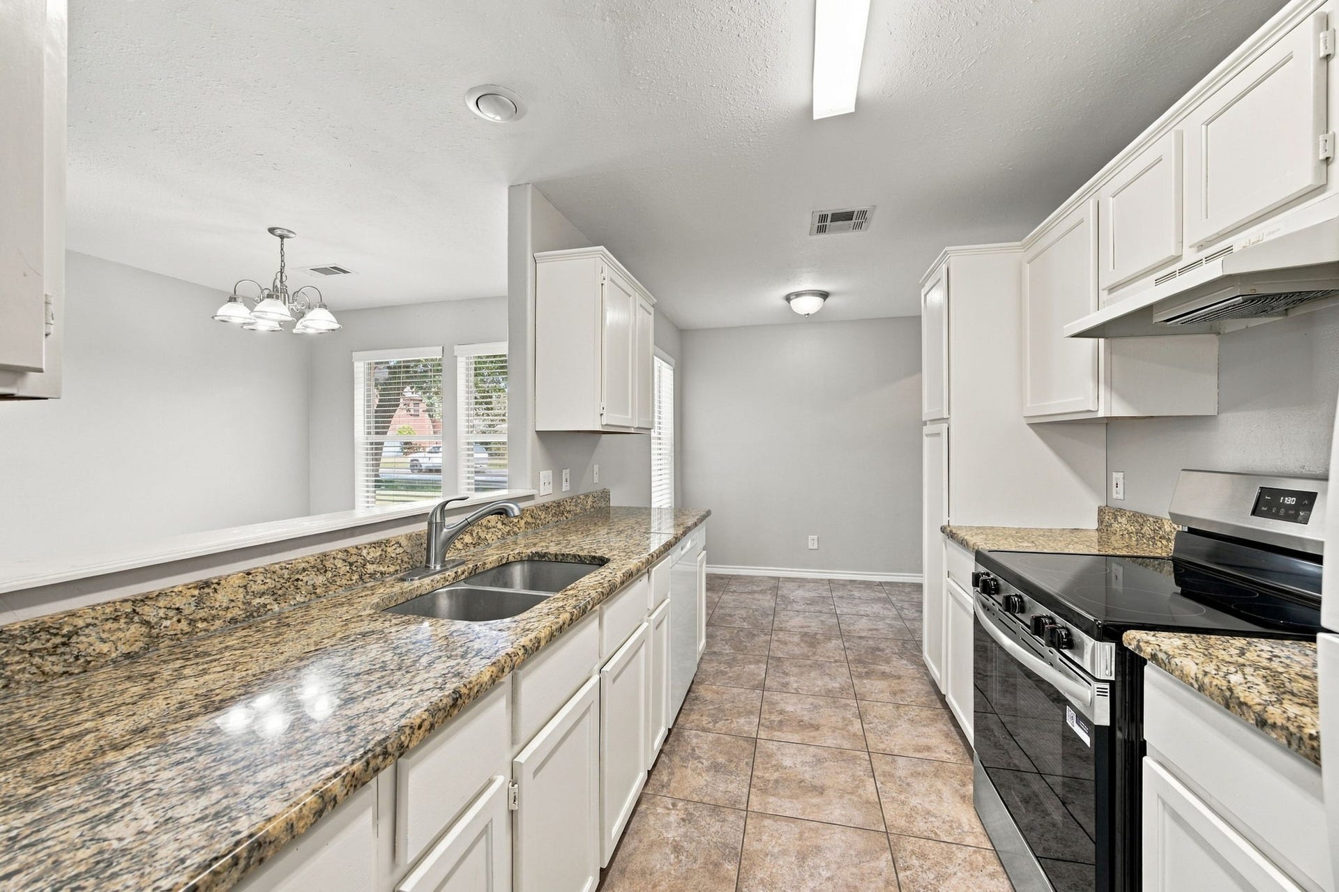 23619 Summer Pine Drive, Spring, TX 77373 Galley kitchen with plenty of space for all your kitchen accessories on the beautiful granite counters.