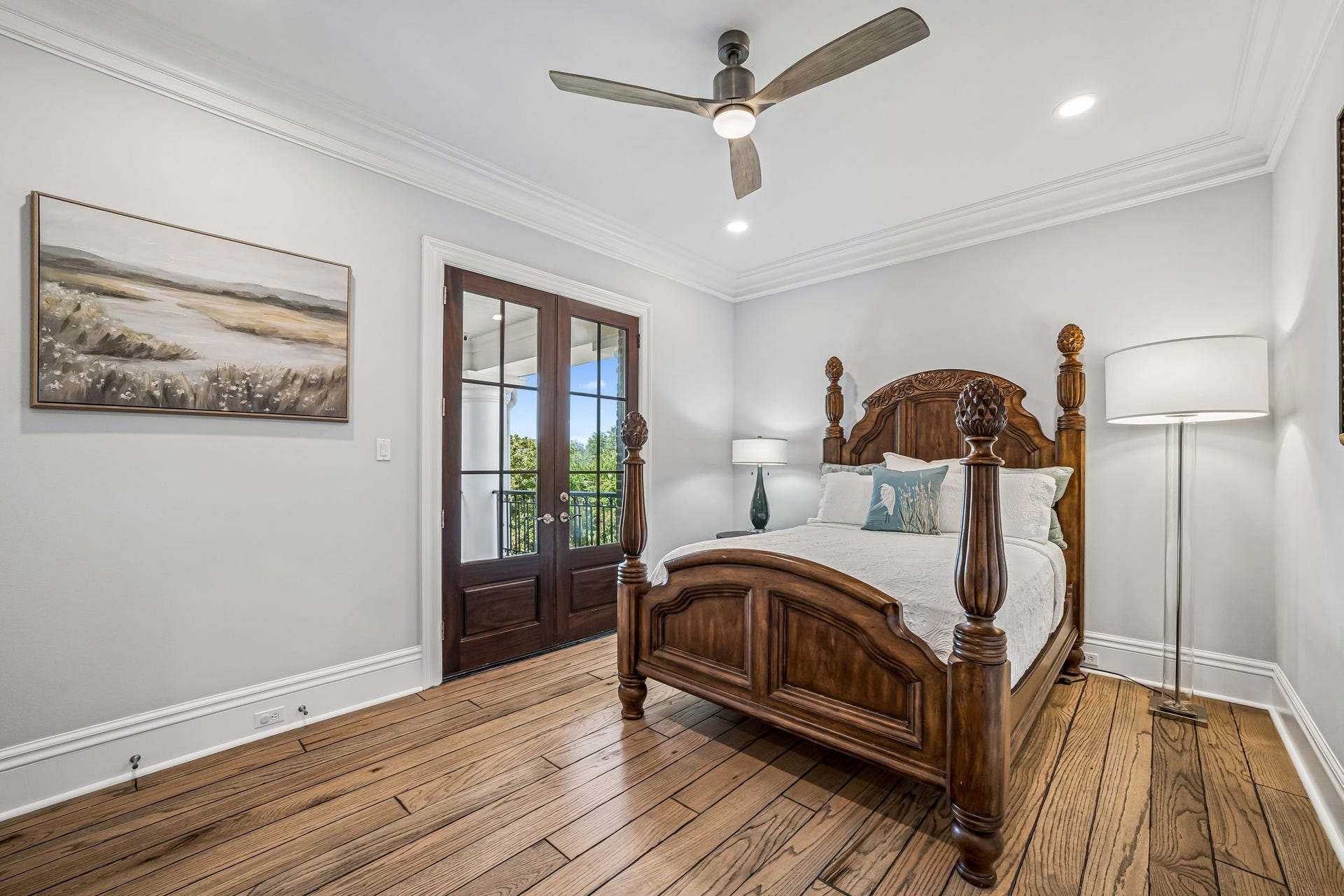 2 Georgian Row, The Woodlands, TX 77380 Spacious secondary bedroom with hardwood flooring, crown molding, recessed lighting, ceiling fan, and French doors providing private access to the veranda.