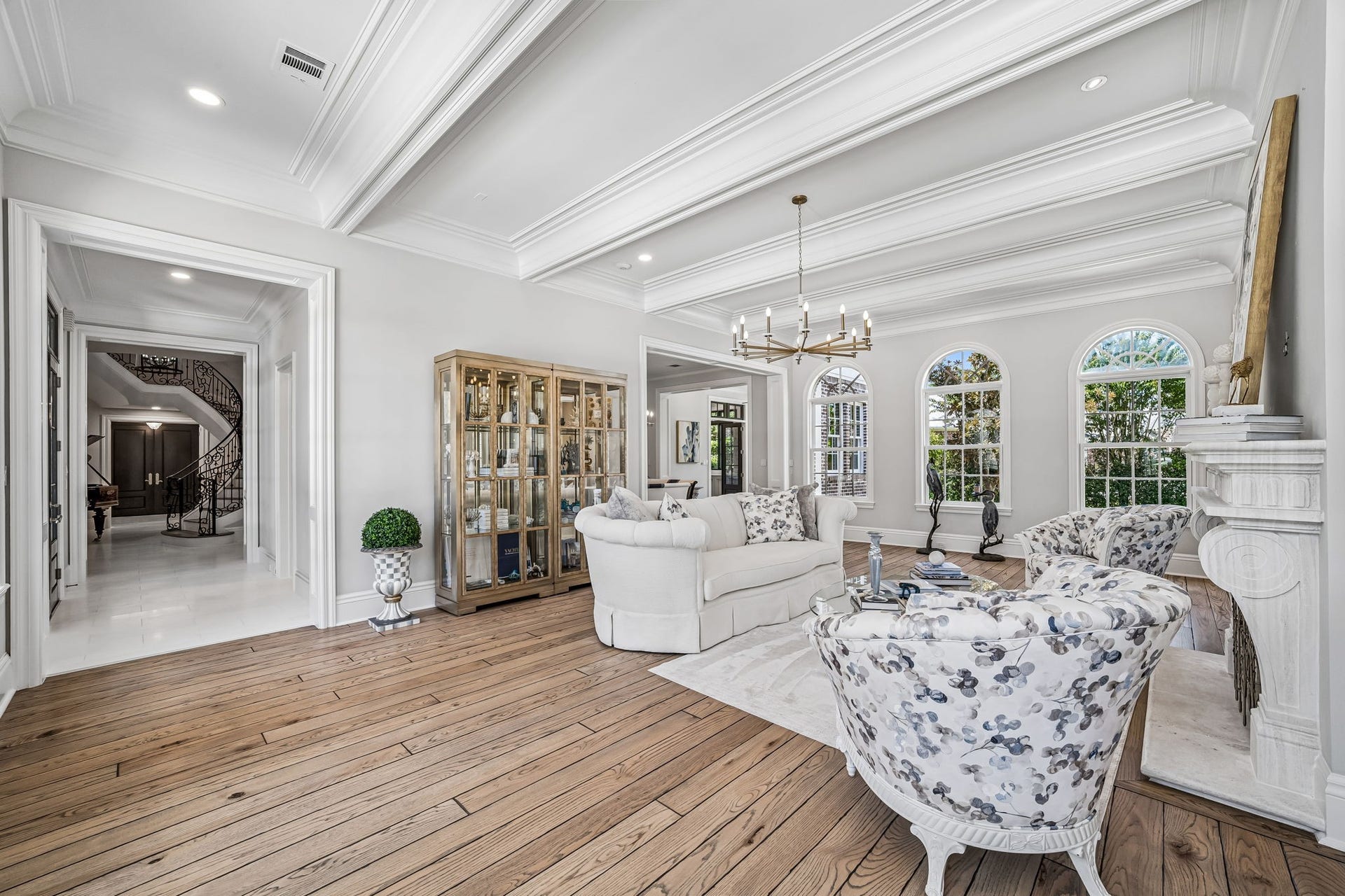 2 Georgian Row, The Woodlands, TX 77380 A stunning perspective of the formal living area with a wide entry leading back toward the homes grand curved staircase and foyer.