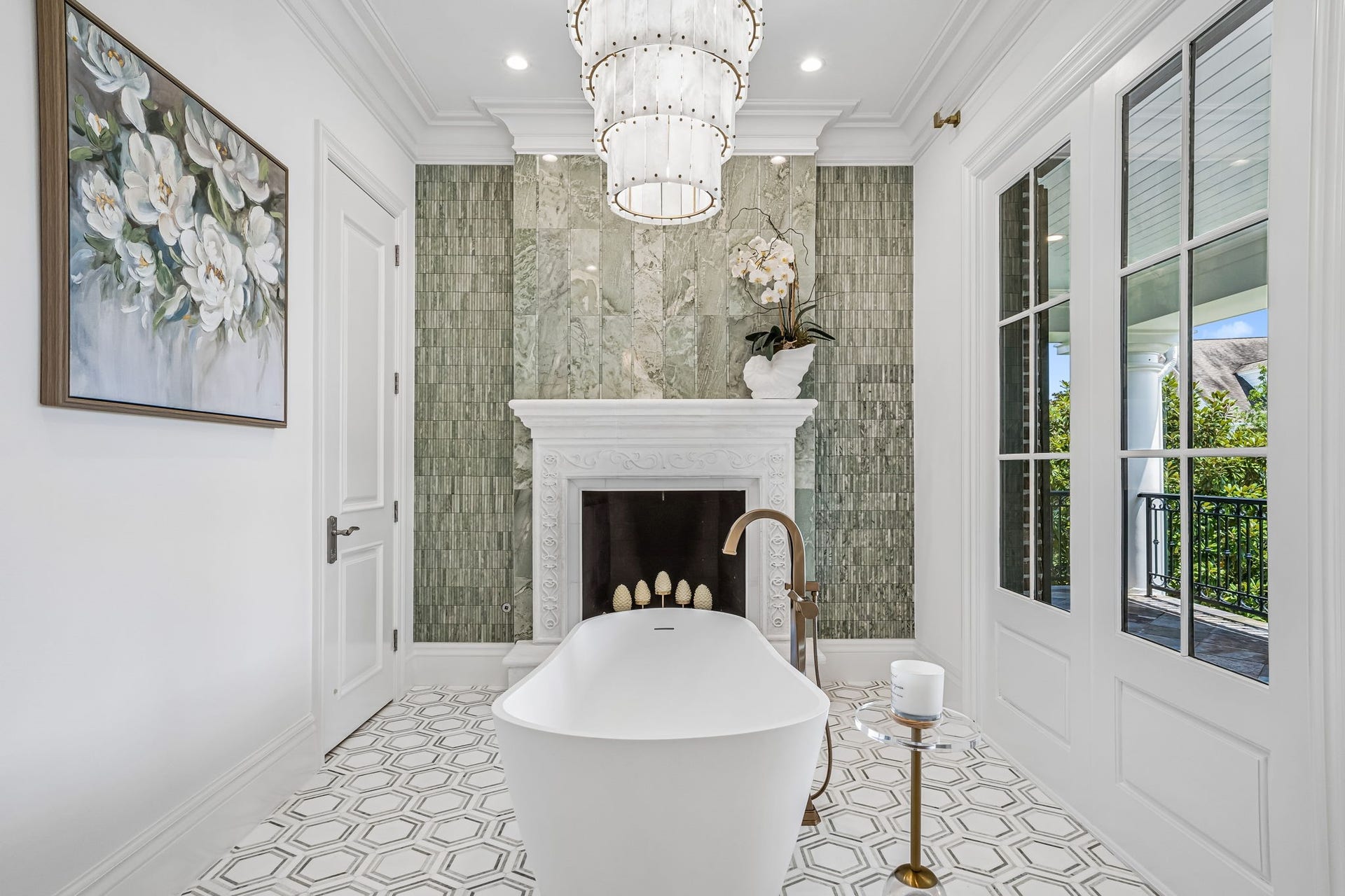 2 Georgian Row, The Woodlands, TX 77380 Showstopping freestanding soaking tub framed by a beautifully detailed fireplace and dramatic floor-to-ceiling green stone and mosaic tilework. Fixed French doors, bringing natural light and outdoor views into this one-of-a-kind primary bath.