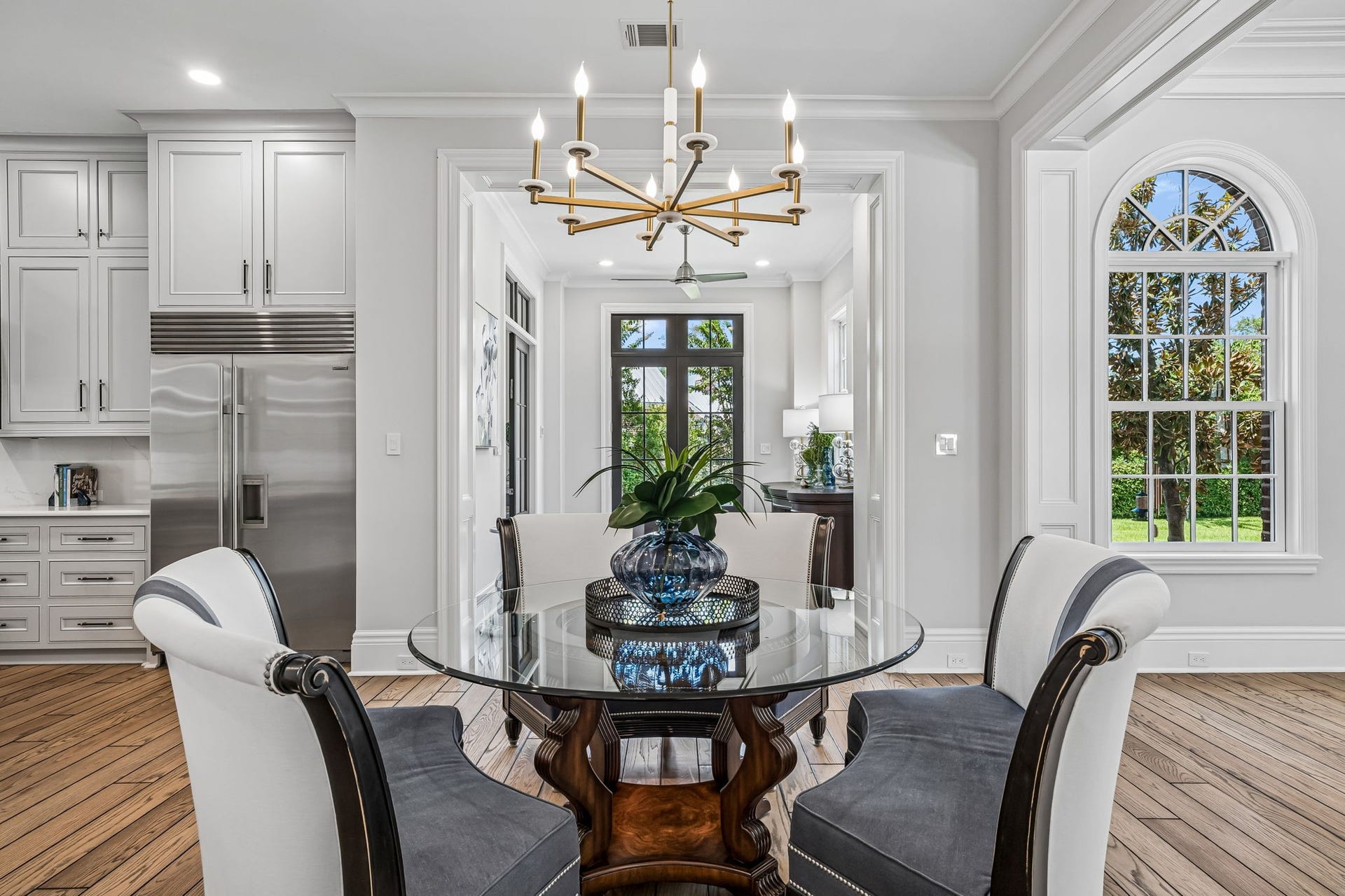 2 Georgian Row, The Woodlands, TX 77380 Through the breakfast room a view of the transition hall to the Chef's kitchen. The French doors lead to large side yard. This space gives an easy connection between the kitchen and surrounding living spaces.