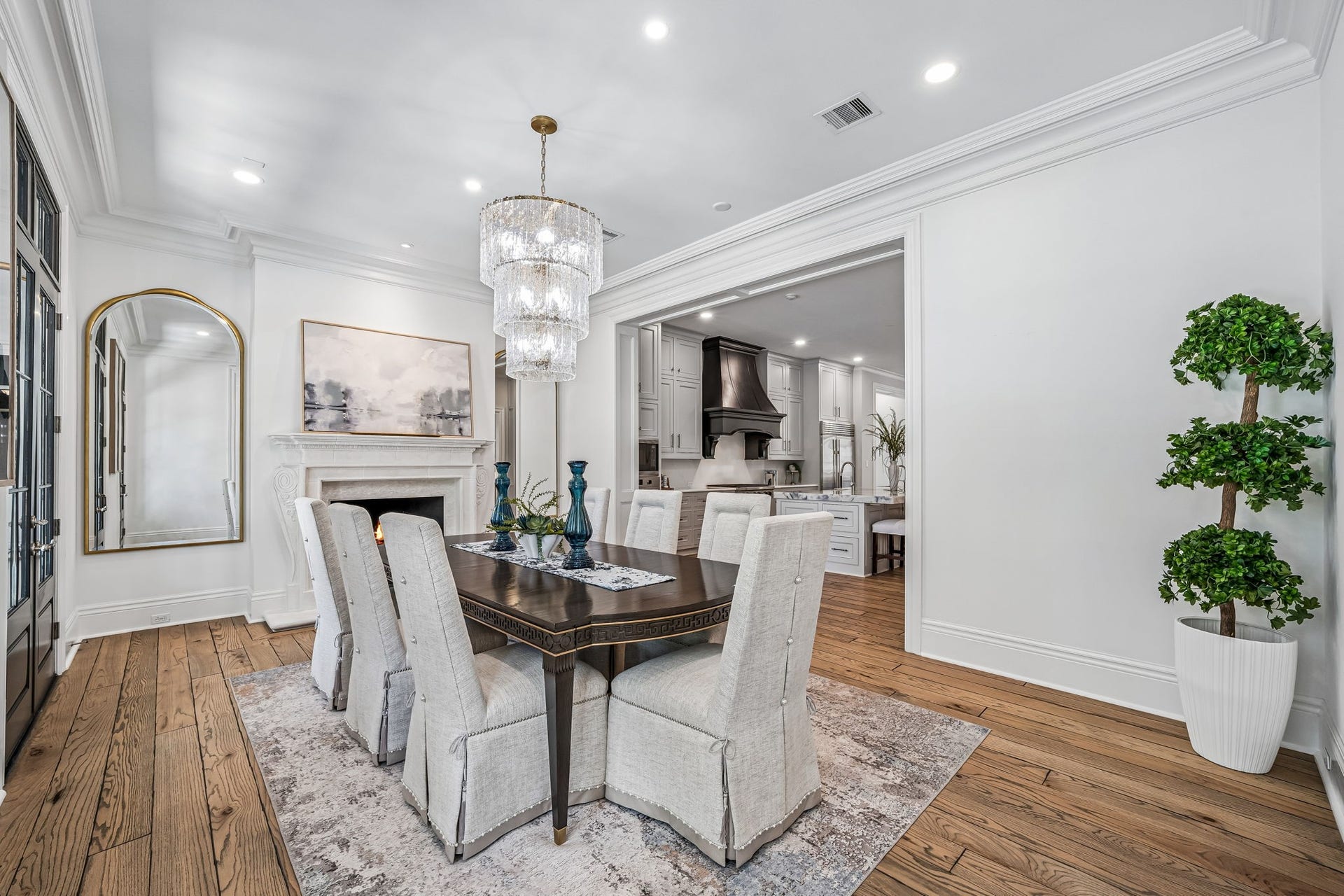2 Georgian Row, The Woodlands, TX 77380 Designed for effortless entertaining, the formal dining room flows directly into the kitchen while maintaining its own refined setting with a fireplace and sophisticated architectural detailing.