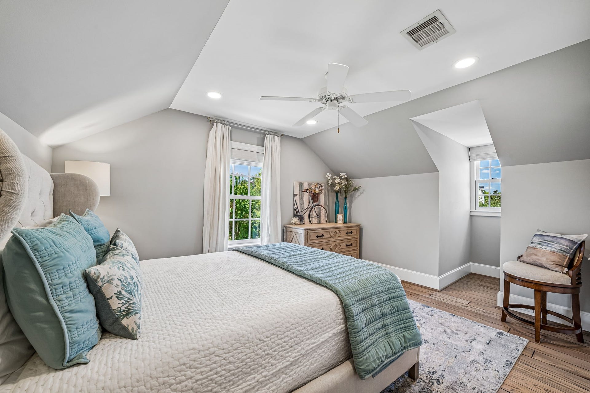 2 Georgian Row, The Woodlands, TX 77380 Private guest suite bedroom with multiple windows bringing in plenty of natural light and overlooking the pool.
