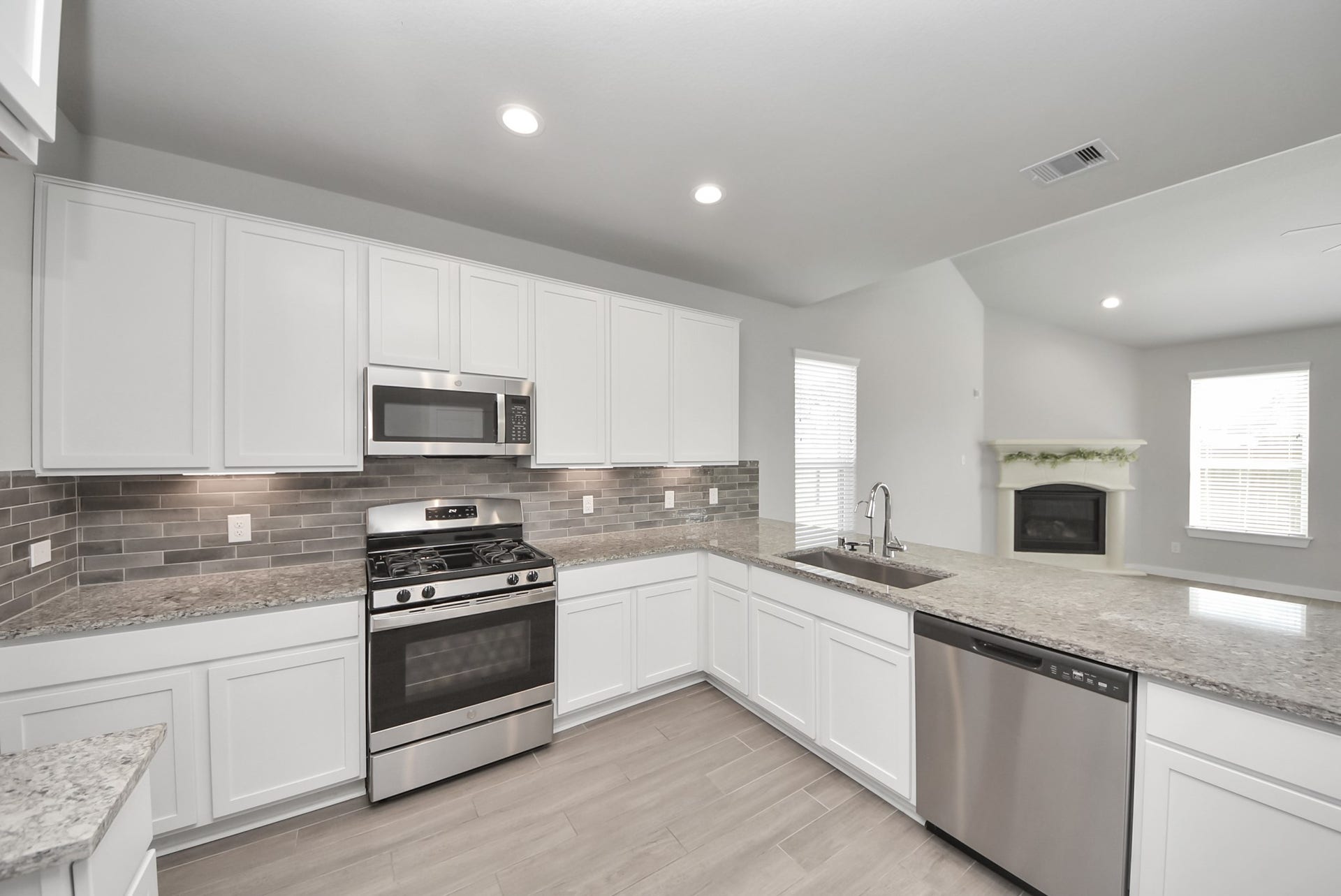 Located on the first floor, this spacious kitchen overlooks the living area, creating an open-concept layout ideal for entertaining and everyday living. Generous counter space and cabinetry offer plenty of room to cook, gather, and make the space your own.