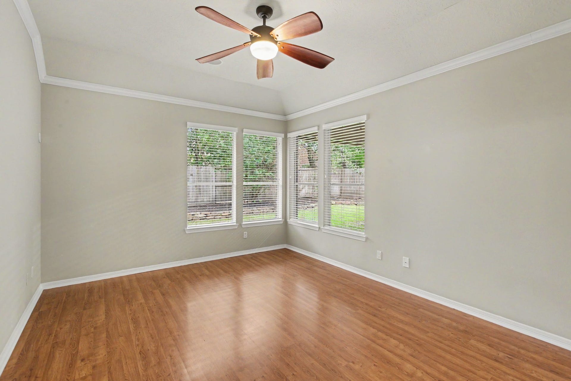 42 S Peaceful Canyon Circle, The Woodlands, TX 77381 The tucked away Owner's Suite with a high ceiling is spacious and bright with beautiful views of the outdoors.