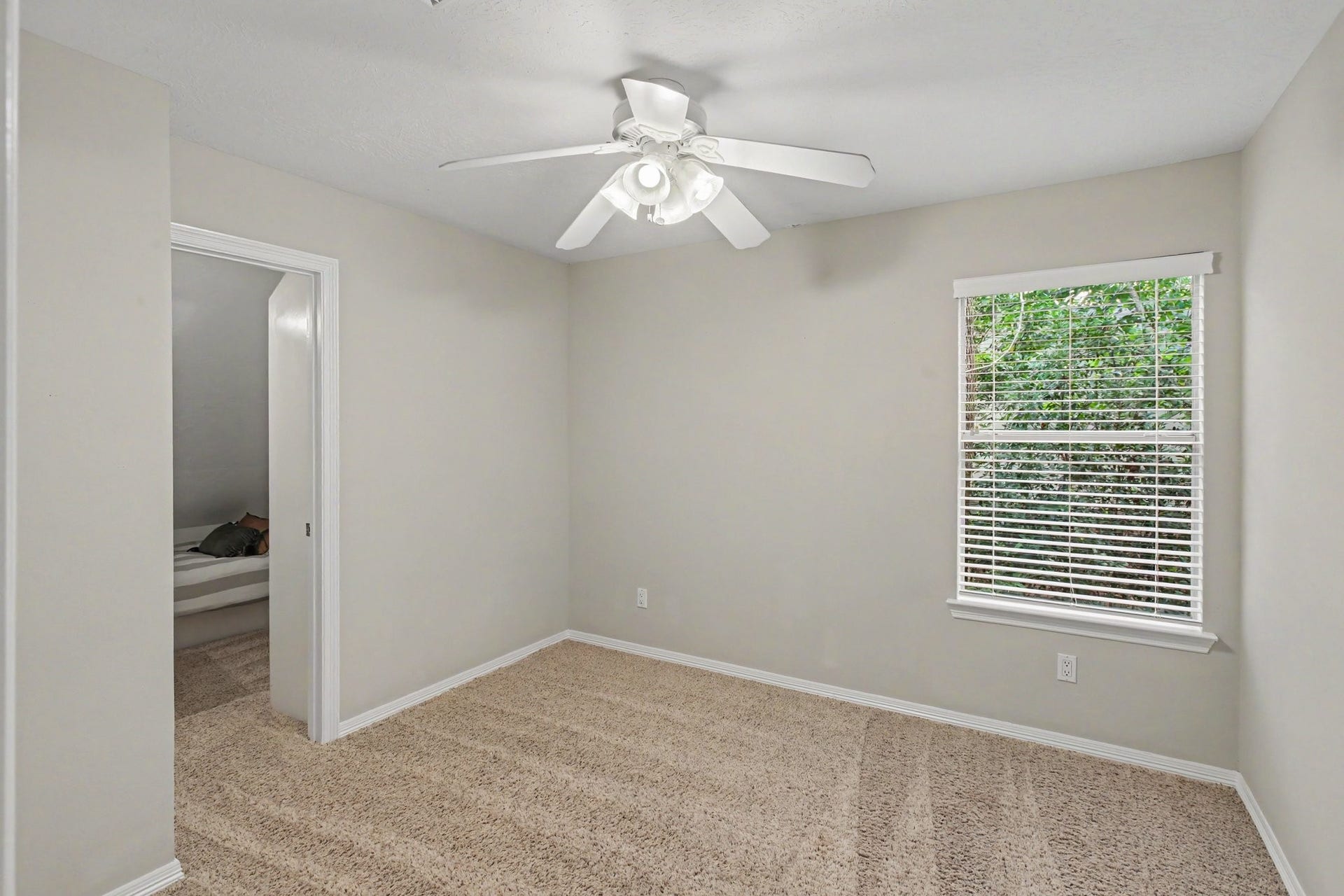 42 S Peaceful Canyon Circle, The Woodlands, TX 77381 This secondary bedroom with carpet and ceiling fan has an amazing closet with a play/bunk room. Check out the next photo!