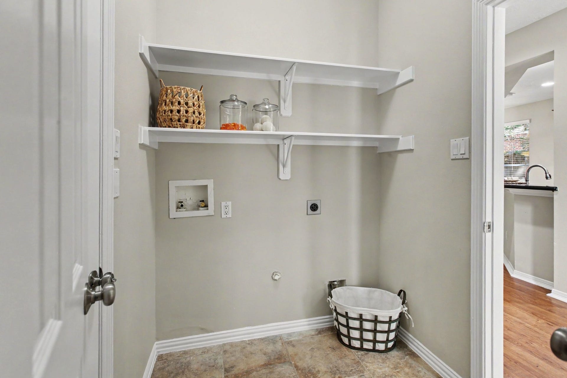 42 S Peaceful Canyon Circle, The Woodlands, TX 77381 The laundry room is located downstairs with a access to the garage and has shelving and a fabulous under stair storage closet.
