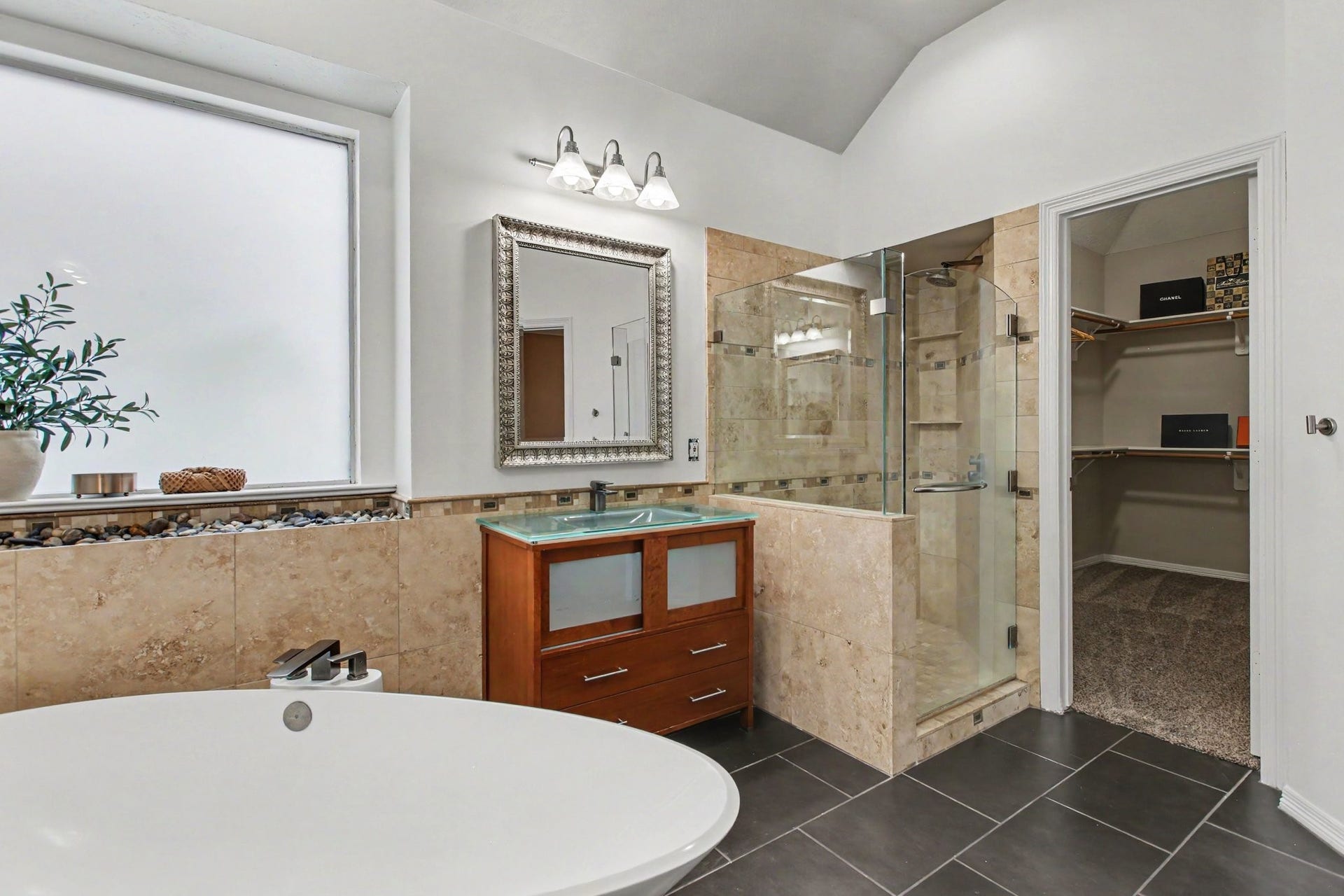 42 S Peaceful Canyon Circle, The Woodlands, TX 77381 Another view of the ensuite bathroom showcasing the walk-in shower with rainfall shower head and built-in shelves and the oversized closet.