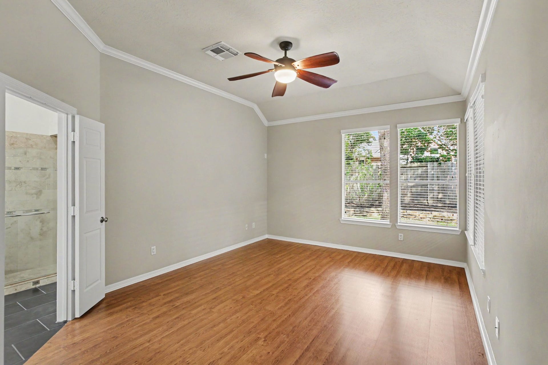 42 S Peaceful Canyon Circle, The Woodlands, TX 77381 An additional view of the Owner's Suite with double doors which encompasses an ensuite bathroom and walk-in closet.