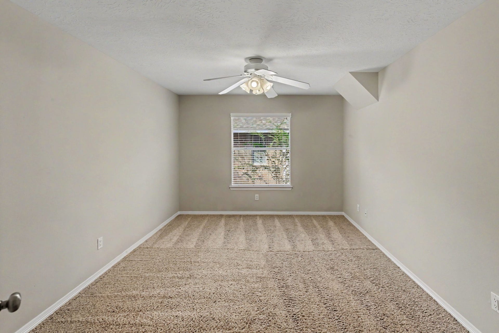 42 S Peaceful Canyon Circle, The Woodlands, TX 77381 The third secondary bedroom upstairs has carpet, a ceiling fan and built-in shelves. The expanded closet with storage has a full size mirror, a built-in desk and access to attic storage.