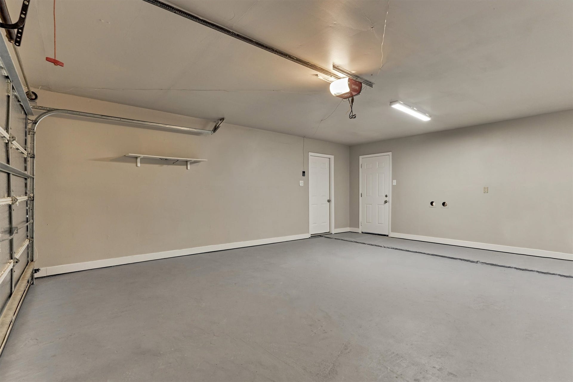 88 W White Willow Circle, The Woodlands, TX 77381 2-car garage, with garage door opener. Reccently painted walls and floor. Door on right goes to backyard. Door on left goes into the kitchen.
