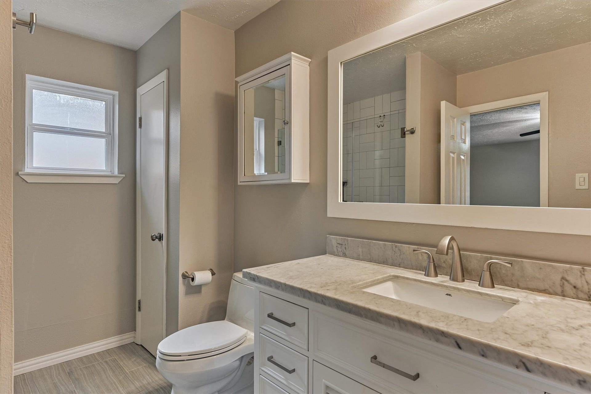 88 W White Willow Circle, The Woodlands, TX 77381 Primary bathroom with upgraded toilet, linen closet, double pane obscure glass window.