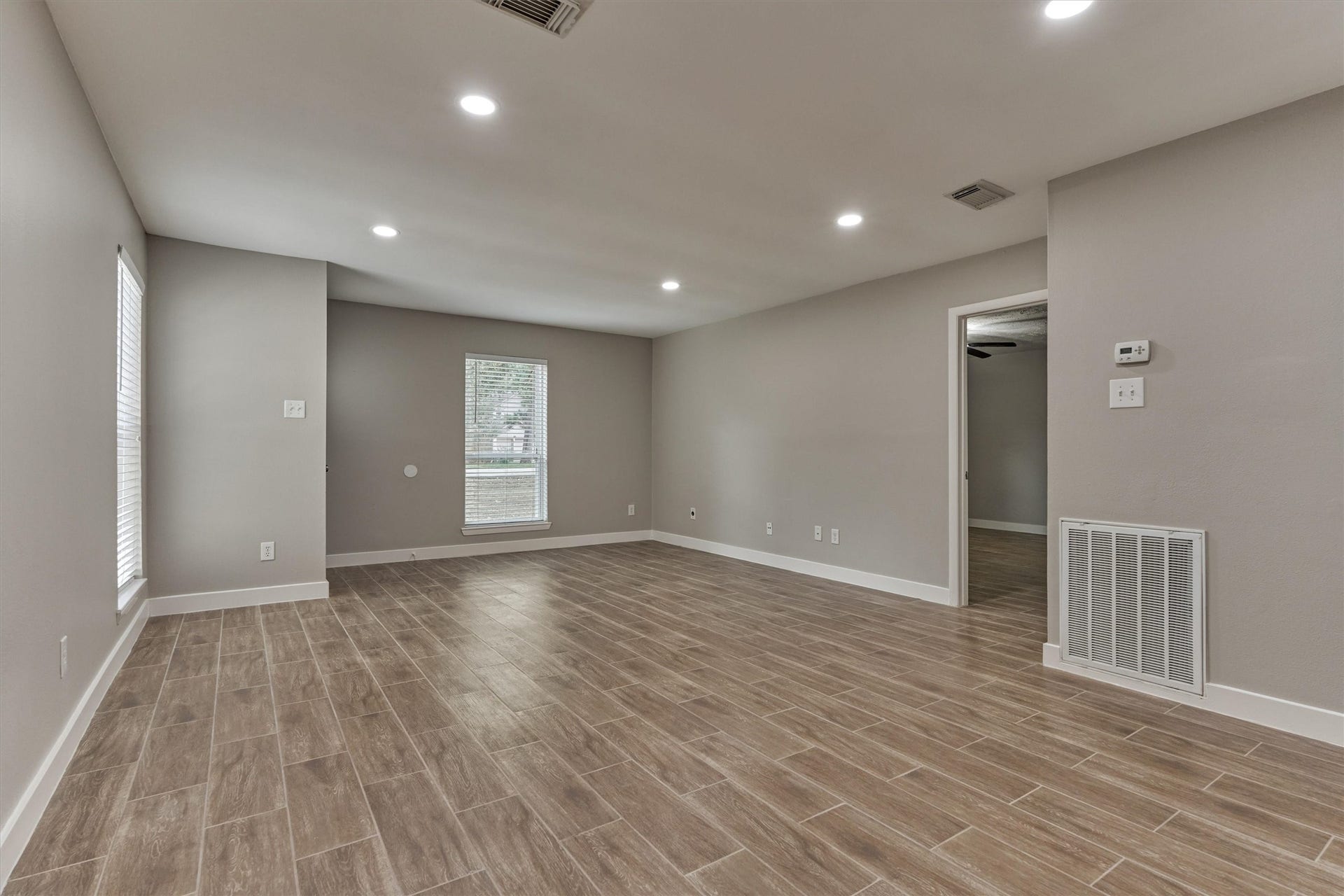 88 W White Willow Circle, The Woodlands, TX 77381 View from dining area looking into the living room. The doorway on right goes into the primary bedroom.
