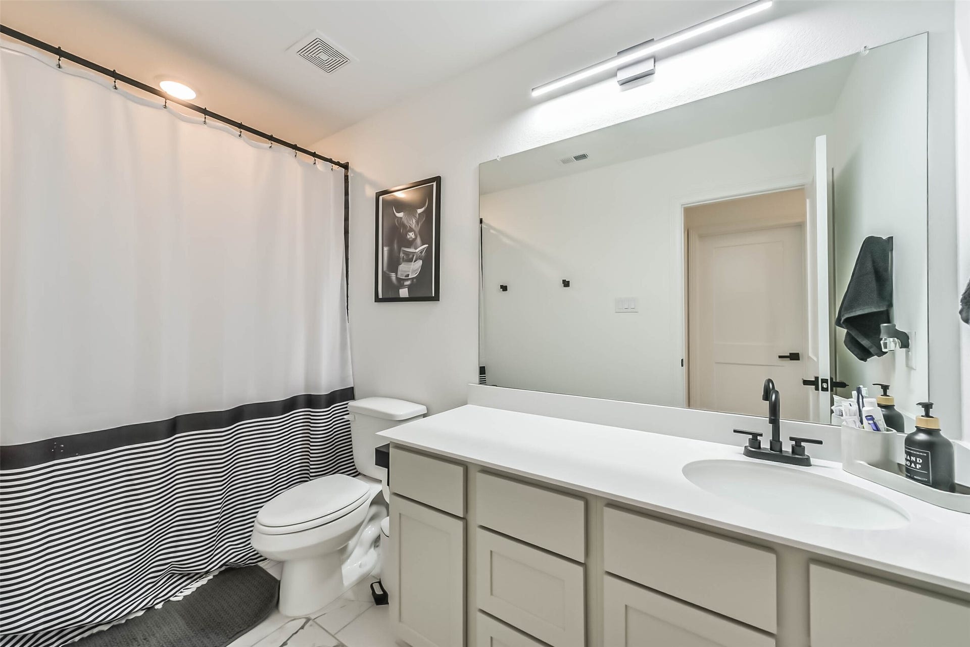 32403 Clouser Crawdad Court, Fulshear, TX 77441 Bathroom with counter and cabinet space and a shower/tub combo.