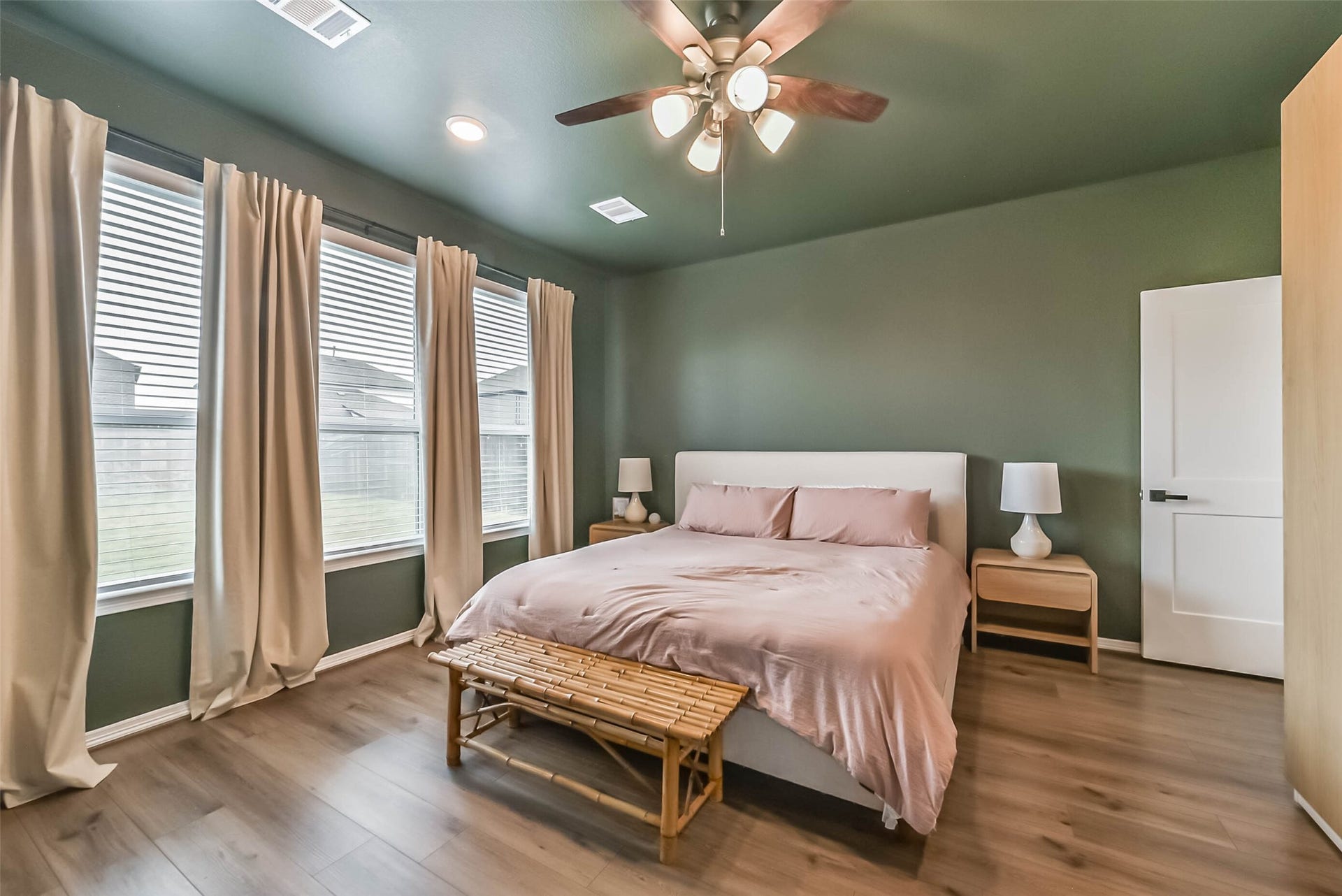 32403 Clouser Crawdad Court, Fulshear, TX 77441 The primary suite is located on the first floor off the living room. Color drenched walls and ceiling provide a cozy and calm ambiance.