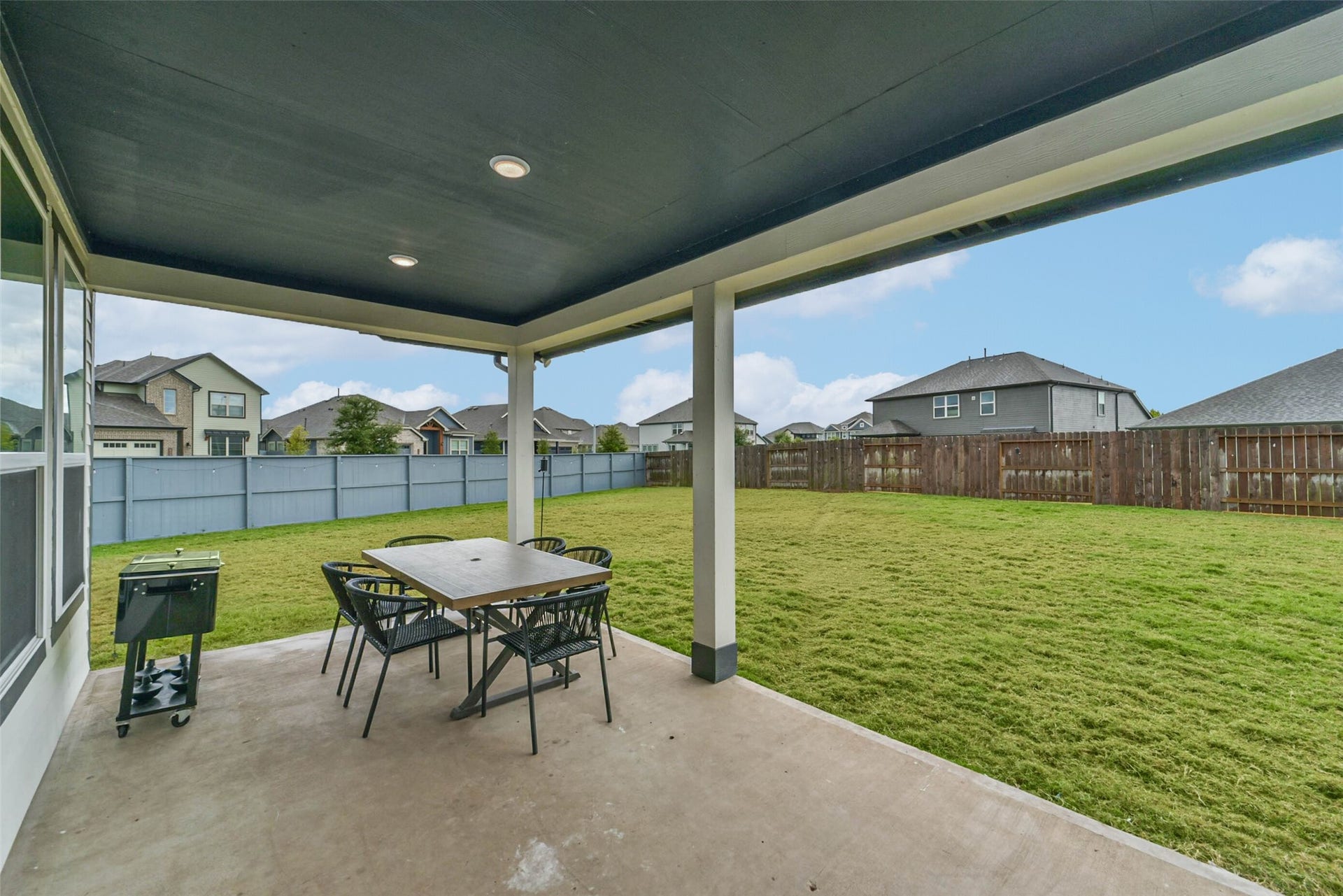 32403 Clouser Crawdad Court, Fulshear, TX 77441 The backyard patio looks out to the extensive backyard. Complete with a gas connection for backyard grilling.