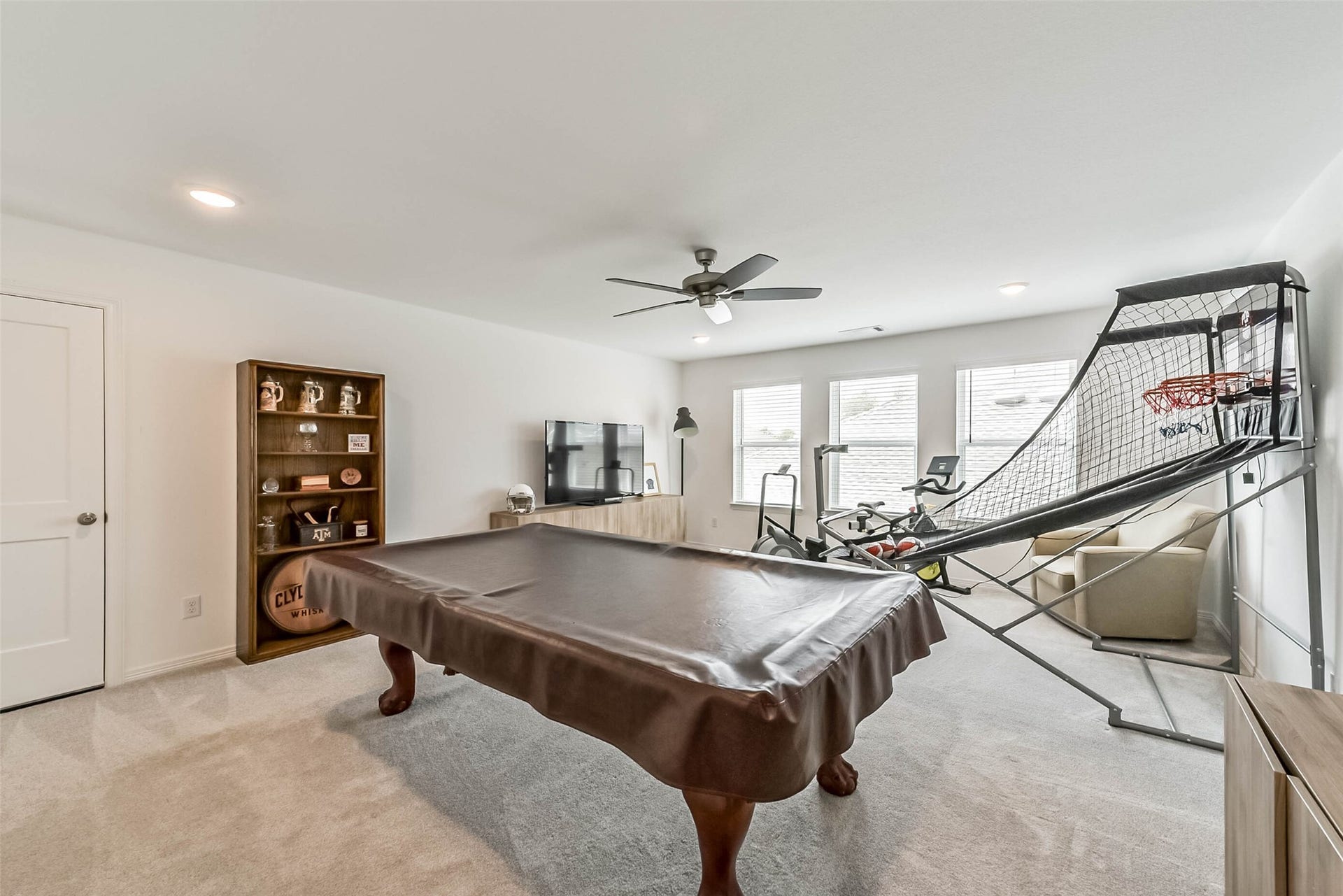 32403 Clouser Crawdad Court, Fulshear, TX 77441 The upstairs gameroom is a large space that can provide a multitude of uses. The door on the left side of the frame leads to the expansive, newly added 50sqft of walkable attic storage space.