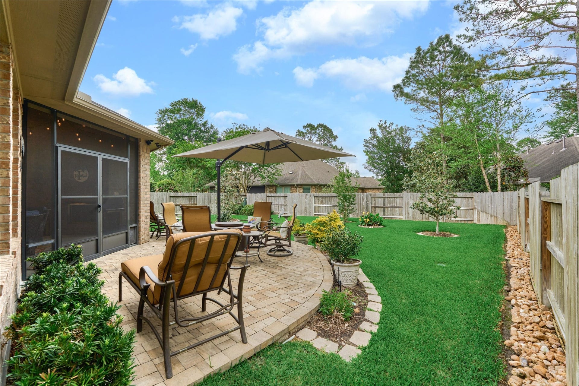 11 S Sandbells Park Lane, Montgomery, TX 77316 Truly a picturesque backyard with impeccable landscaping and timeless patio area.