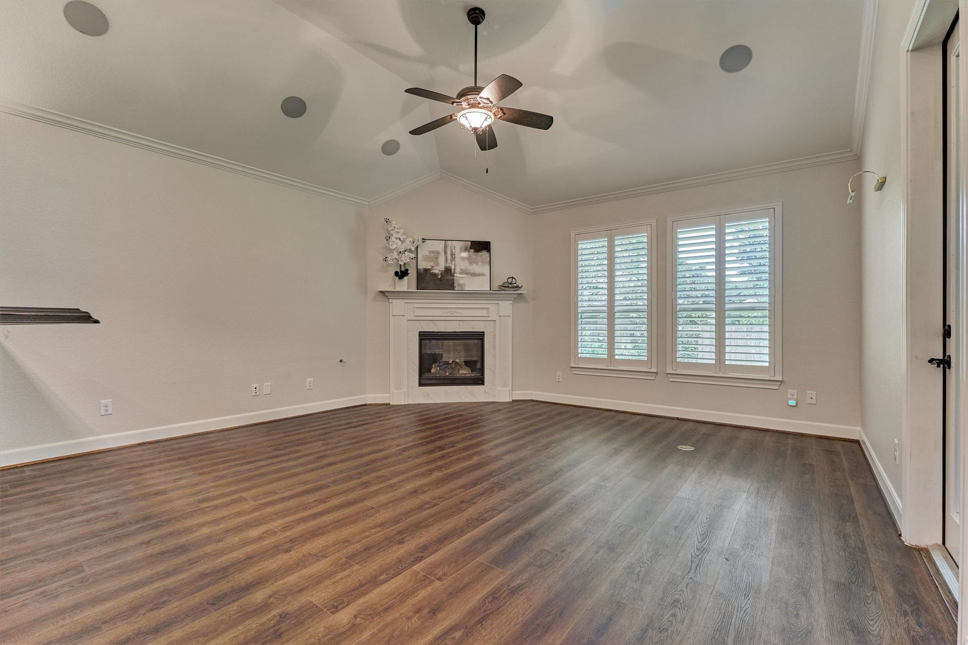 11 S Sandbells Park Lane, Montgomery, TX 77316 Den with cozy fireplace and windows overlooking the serene rear grounds.