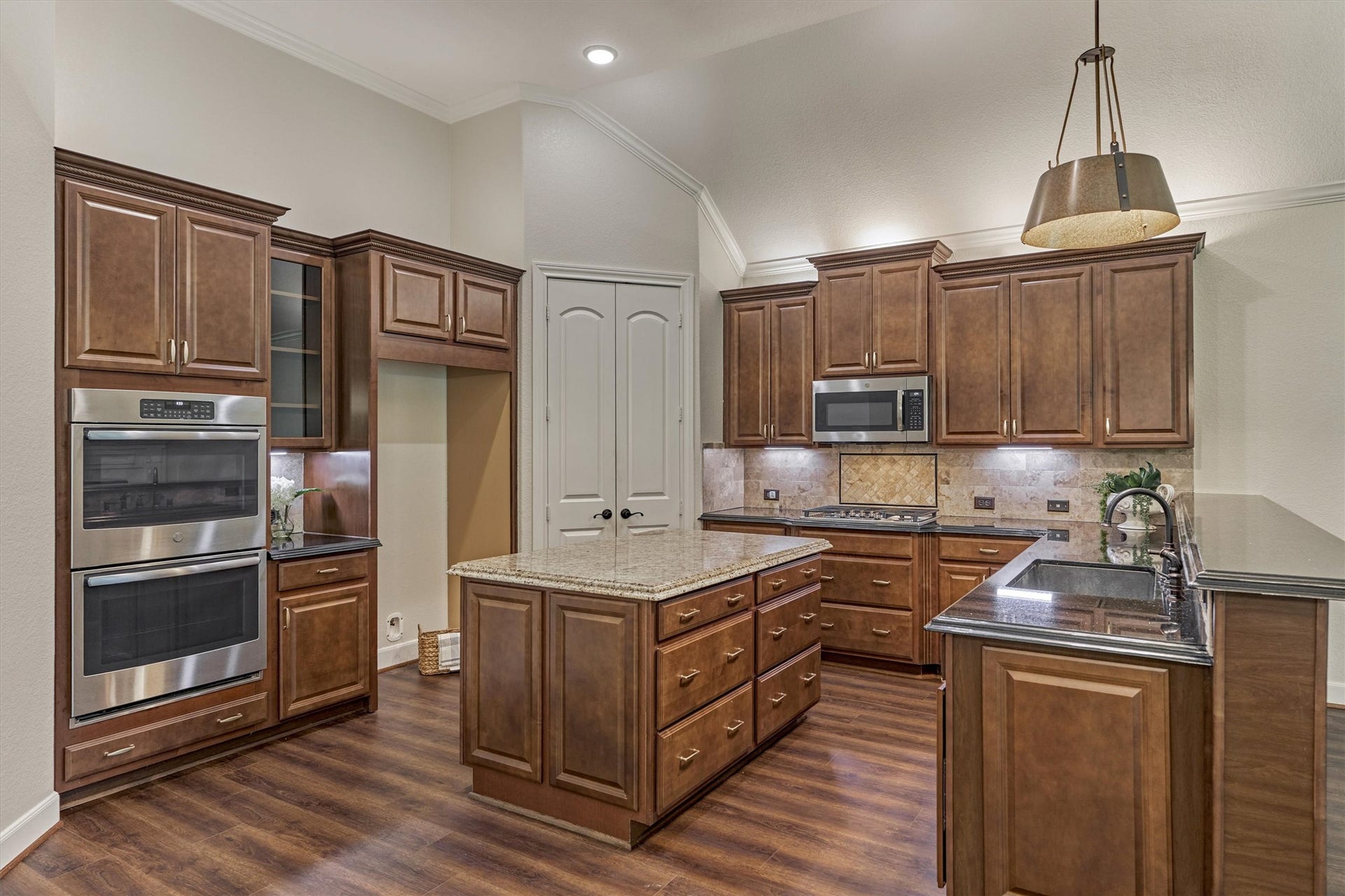 11 S Sandbells Park Lane, Montgomery, TX 77316 Chef's kitchen is optimally spacious with tons of cabinetry and counterspace, featuring a long dining bar that opens to the cozy den.