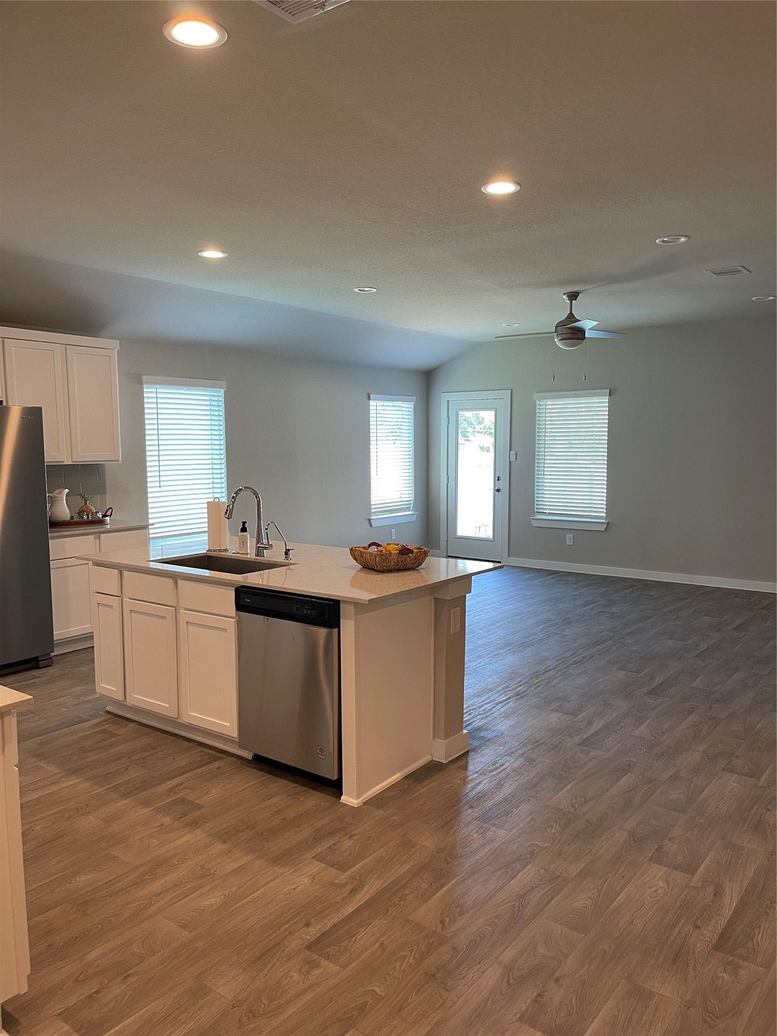 12285 Council Grove Drive, Conroe, TX 77384 Spacious open-concept kitchen and living area featuring modern stainless steel appliances, and abundant natural light through large windows.