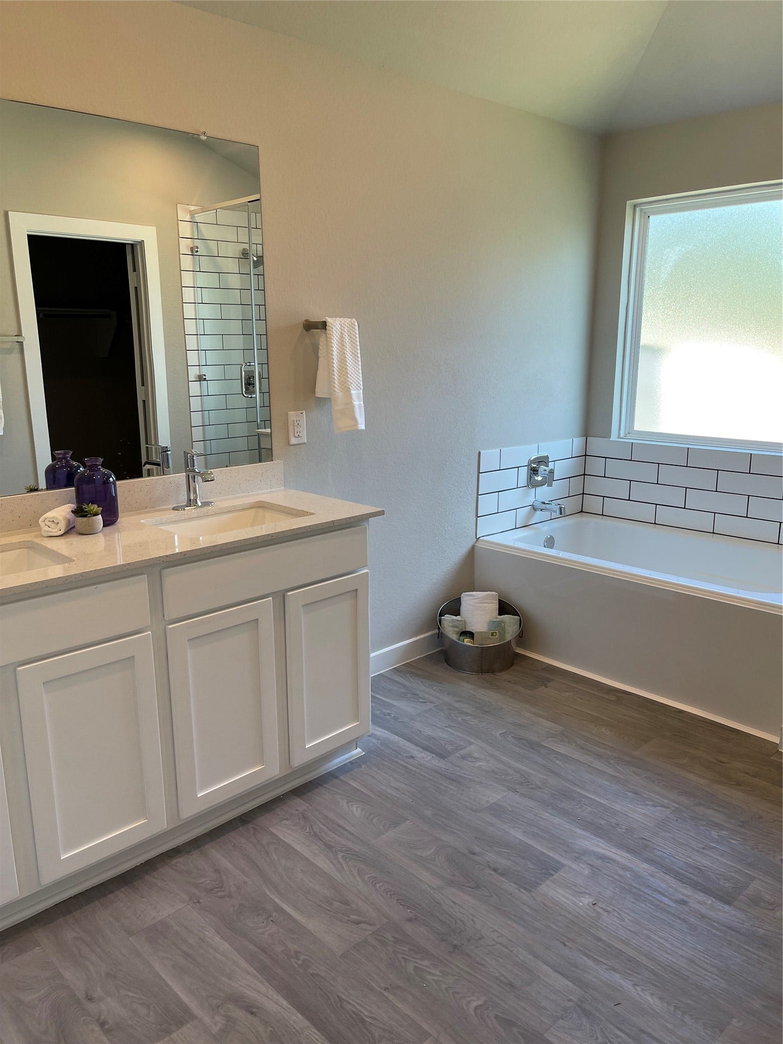 12285 Council Grove Drive, Conroe, TX 77384 Bright and modern bathroom featuring a sleek double vanity, spacious soaking tub, and stylish subway tile accents.